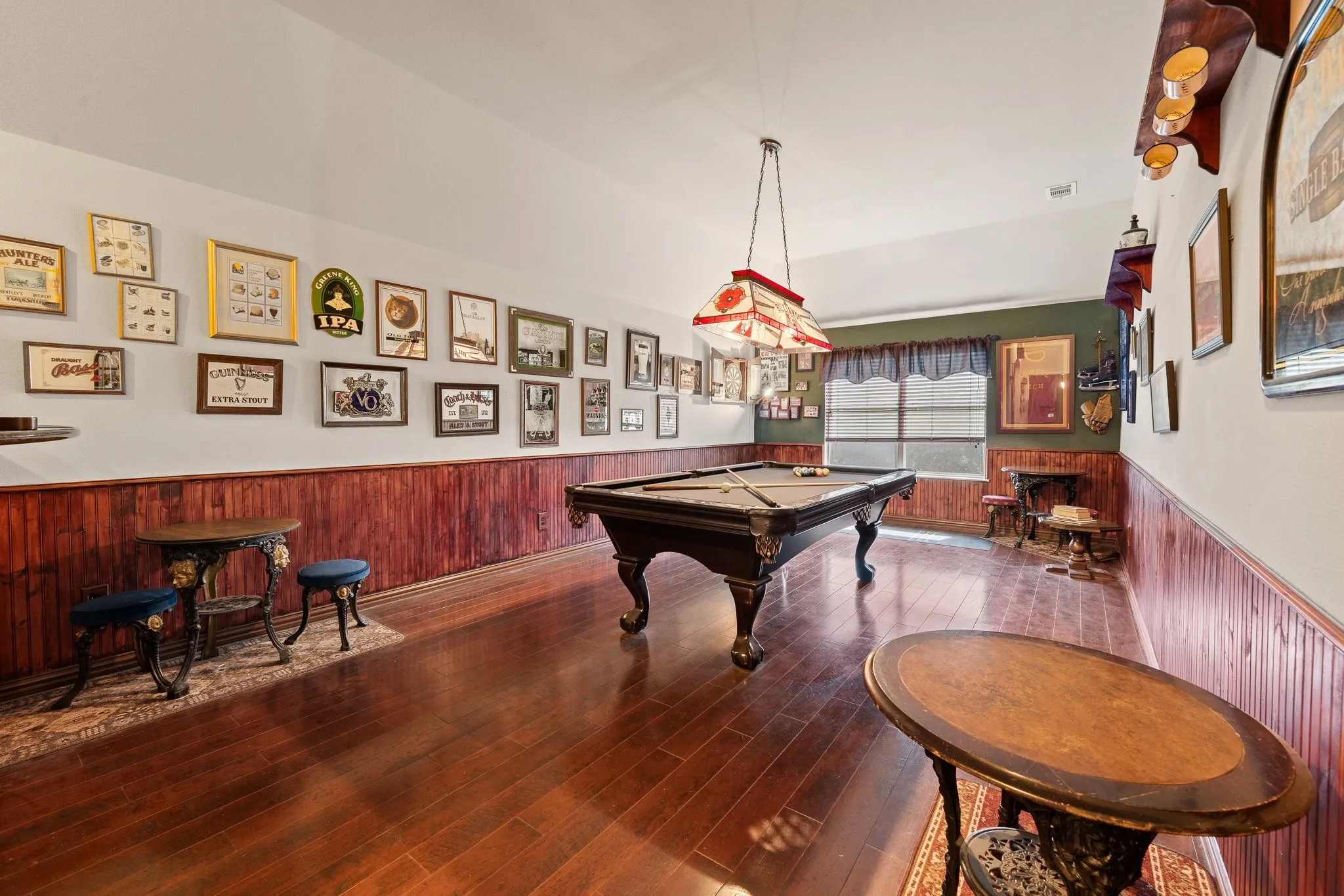 Upstairs Oversized Game Room features wood flooring and paneling, decorative light fixture, and offers extra dining & sitting areas too! POOL Table & Dart Board CONVEYS!!