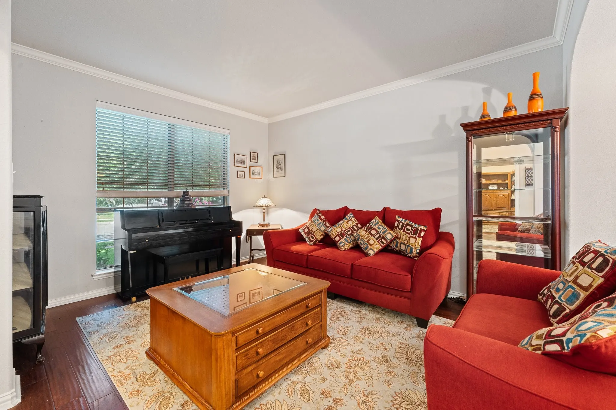 Front Formal Living Room features Wood Flooring and Crown Molding... OPENS to Entry and Dining...