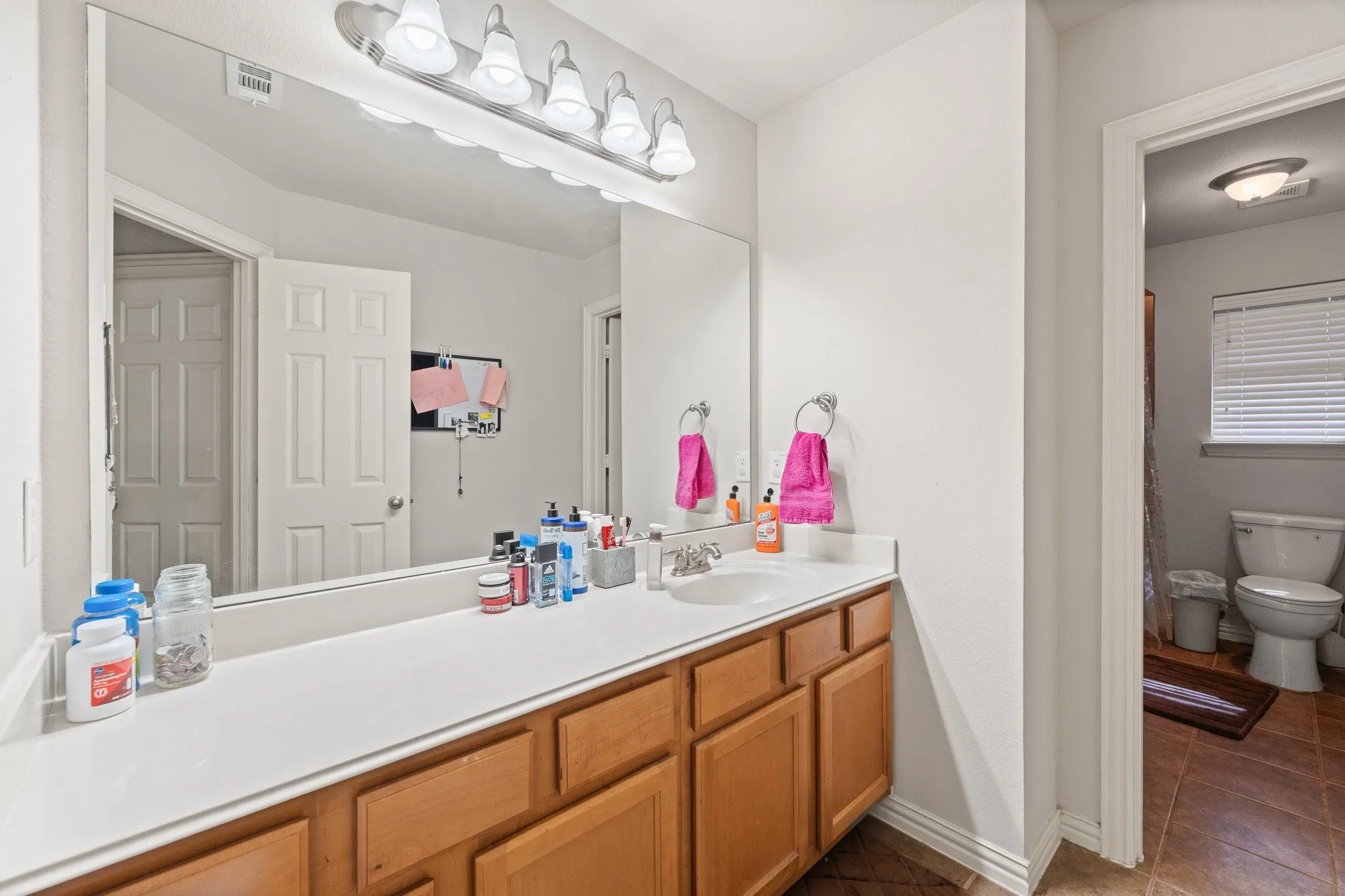 3rd FULL Bath located Upstairs: Large vanity with sink, lots of storage cabinets, and PRIVATE door to Tub/Shower Combo Potty room; serves 3 Upstairs Bedrooms!
