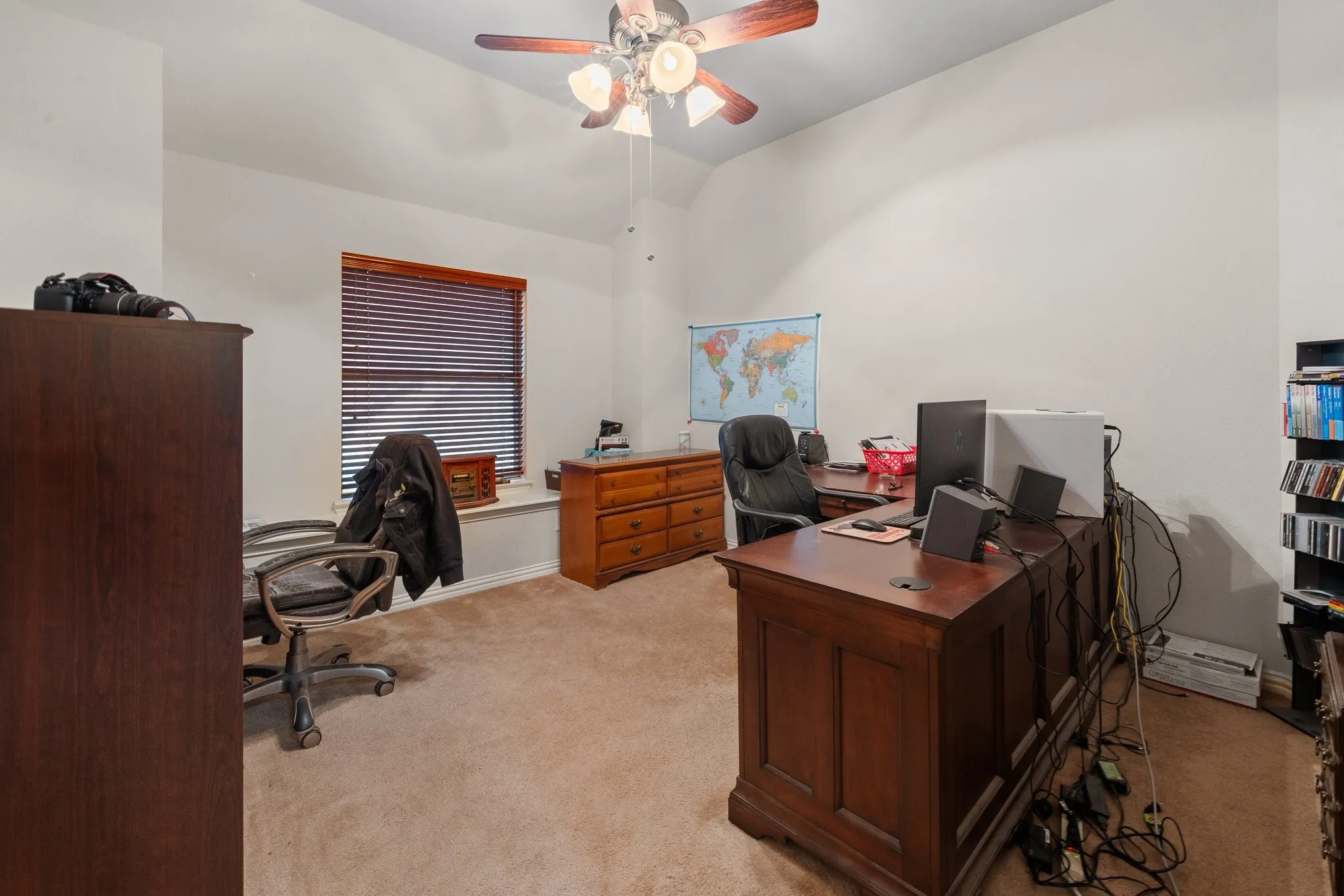 Upstairs Bedroom 5: Window Seat, sloped ceiling, wood-finish ceiling fan with integrated lighting, and wood-finish blinds.