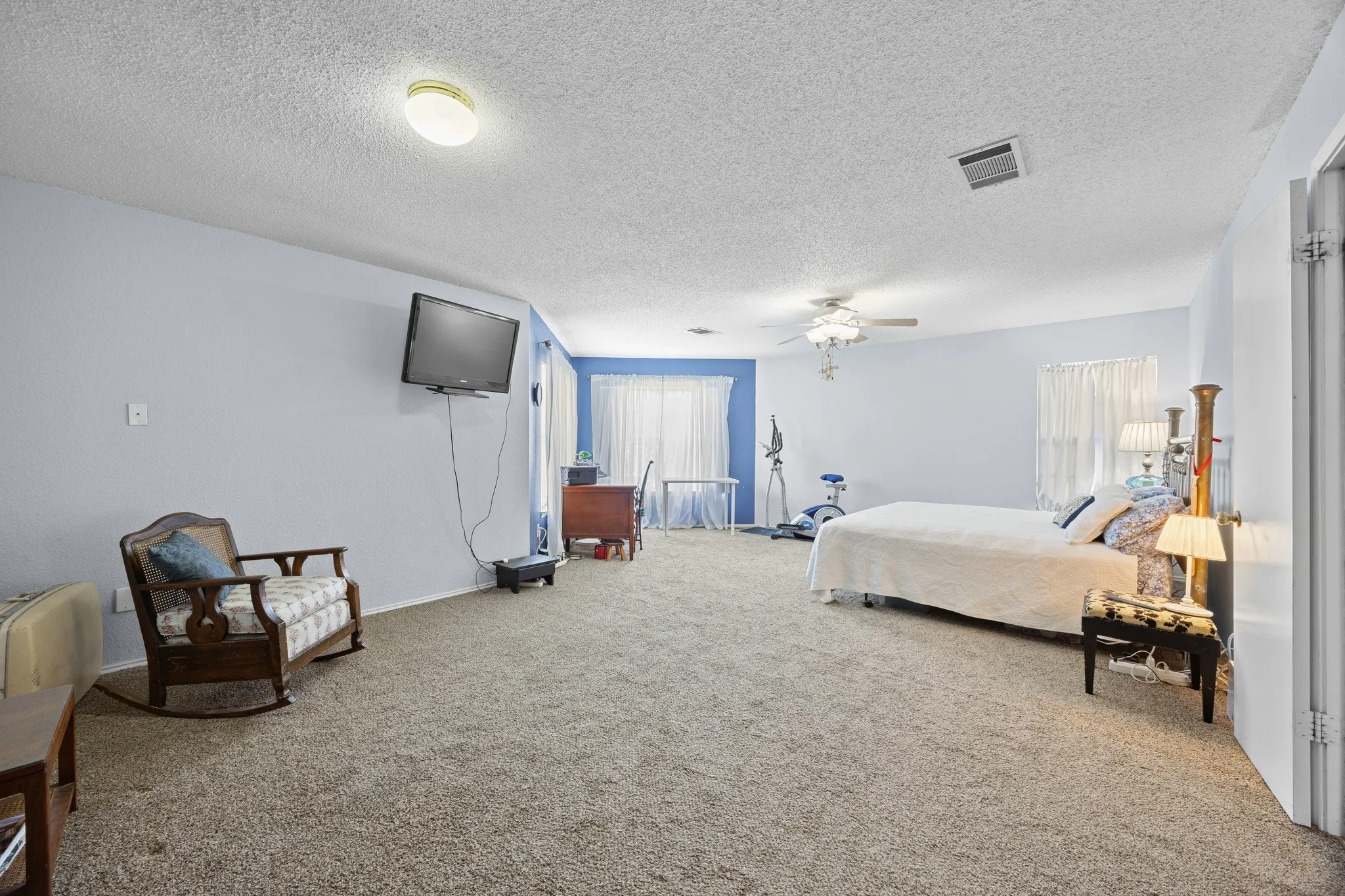 Light blue painted walls with a ceiling fan overhead