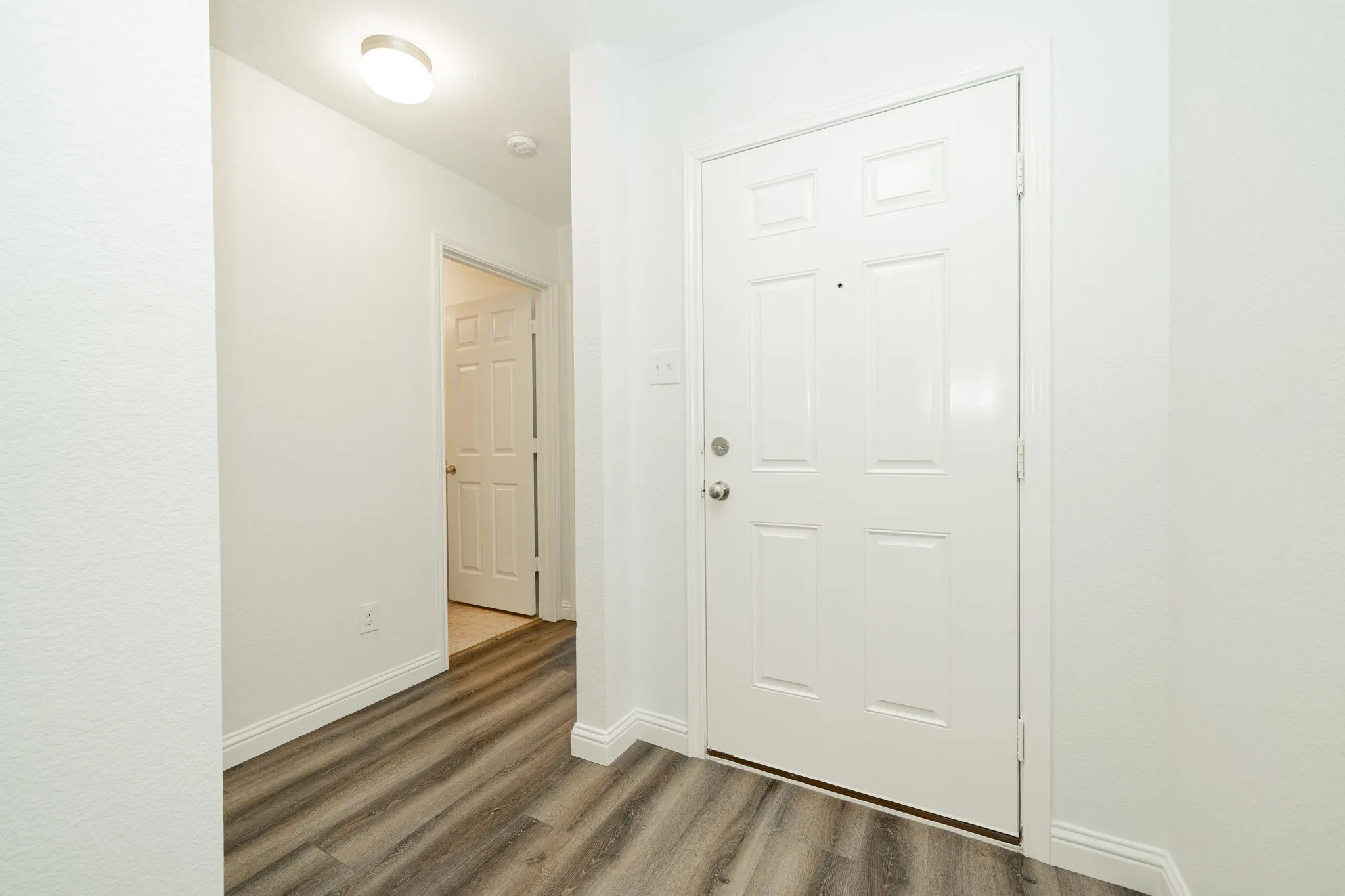 Entryway with wood finished floors and baseboards