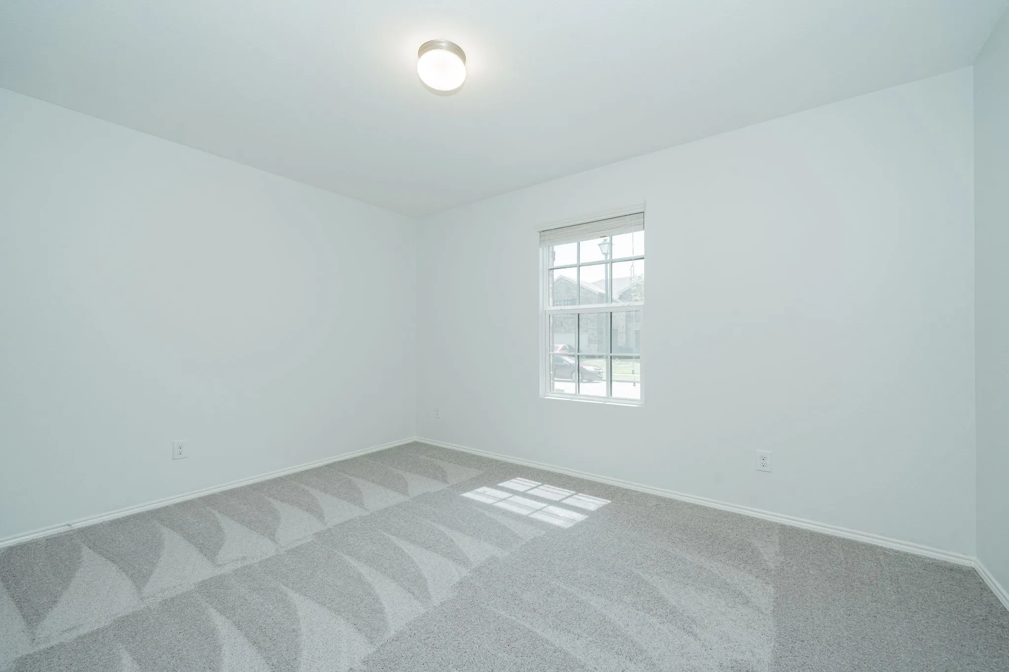 Unfurnished room featuring carpet and baseboards