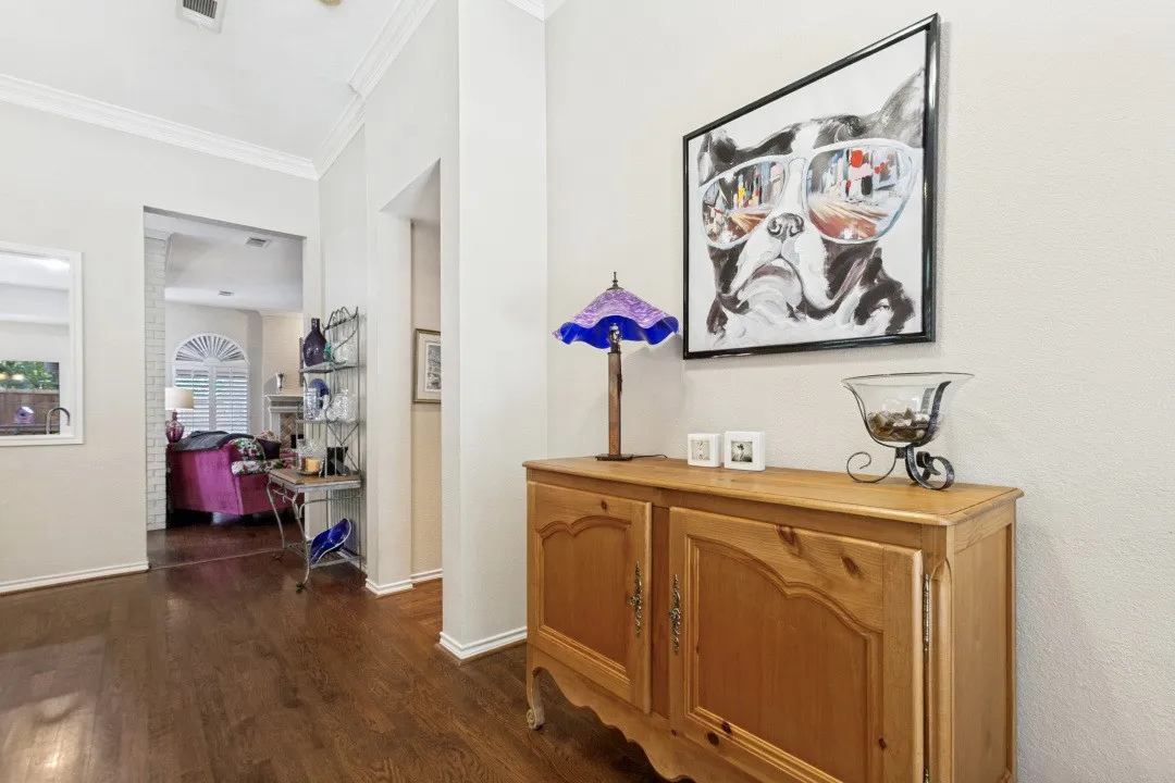 Wood-finish flooring throughout, with white crown molding and baseboards