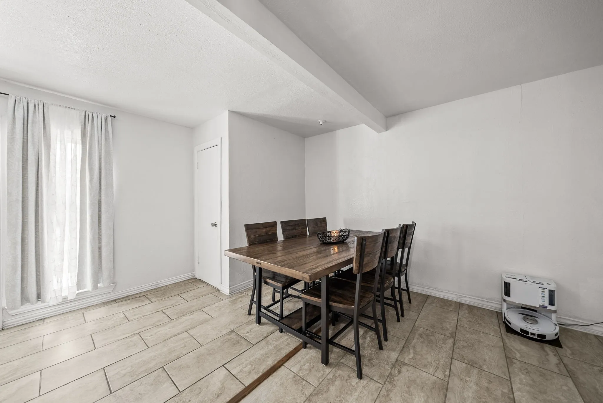 Neutral wall tones complemented by tile flooring