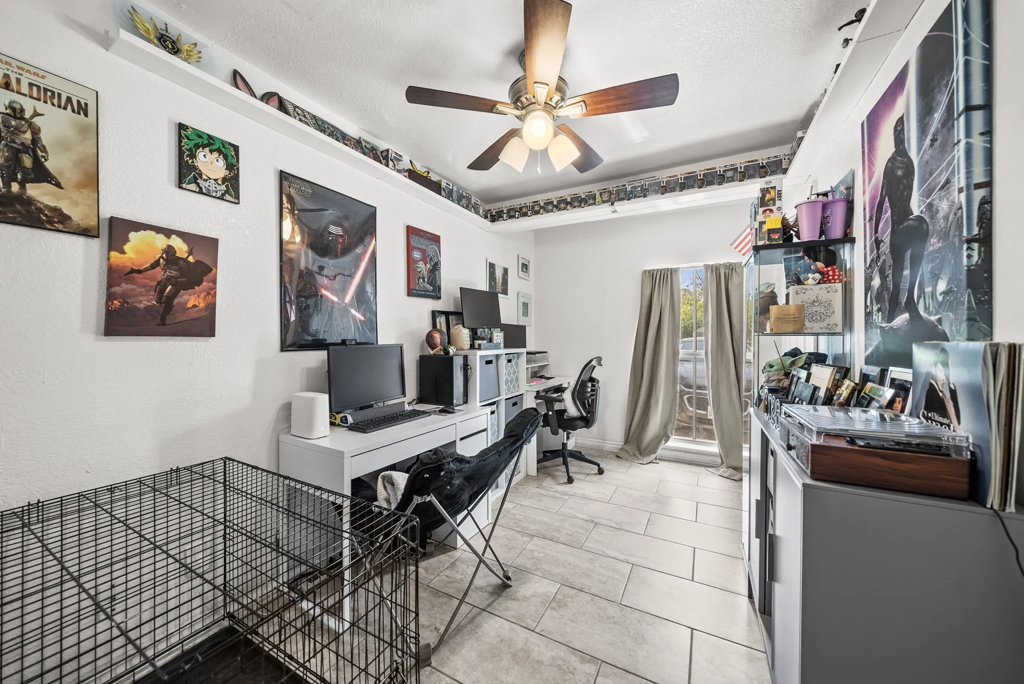 White walls, recessed upper shelving, ceiling fan with light fixture, tiled flooring, and a window with neutral drapes