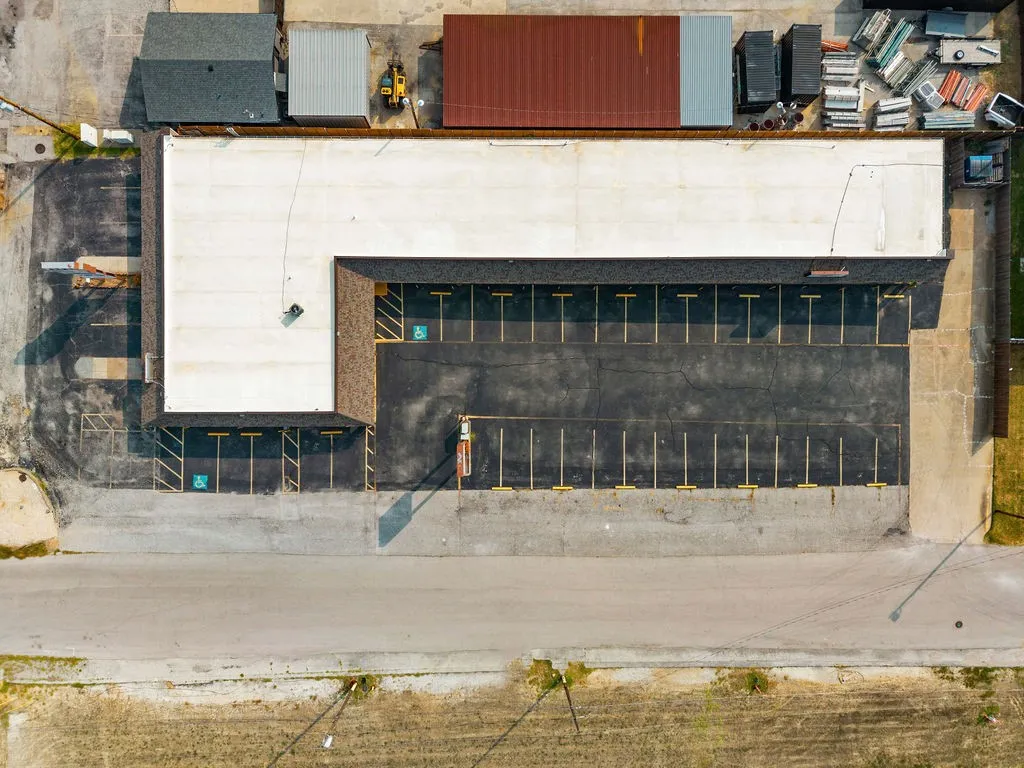 Expansive asphalt parking lot with multiple marked spaces