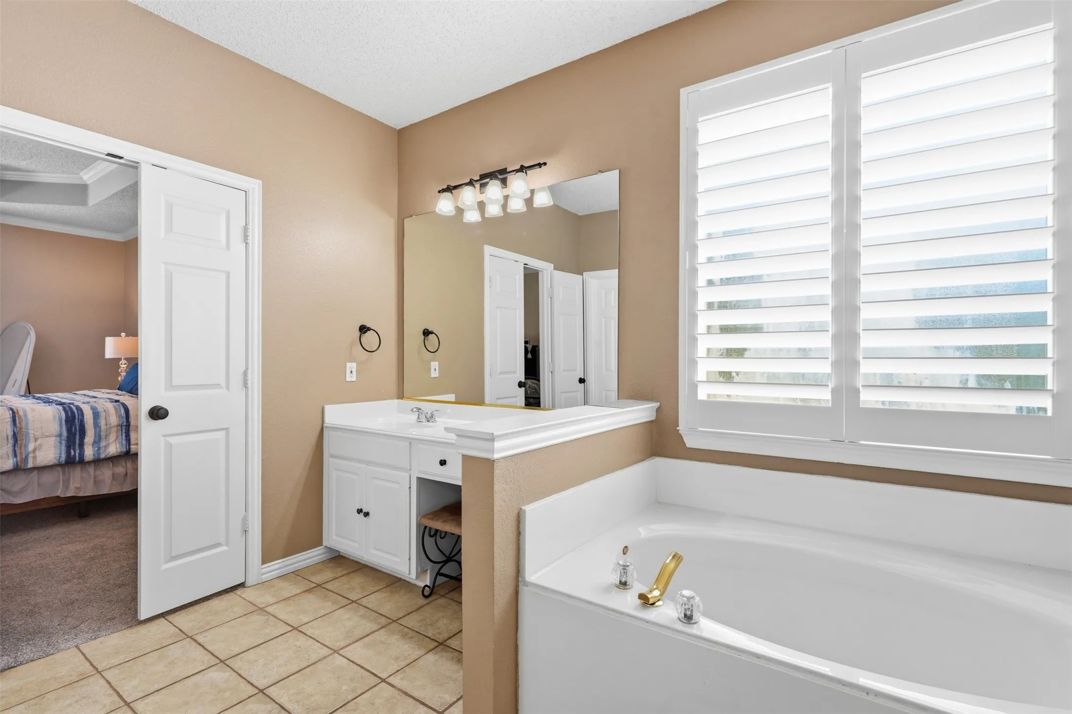 Primary bath with garden tub and separate vanities.