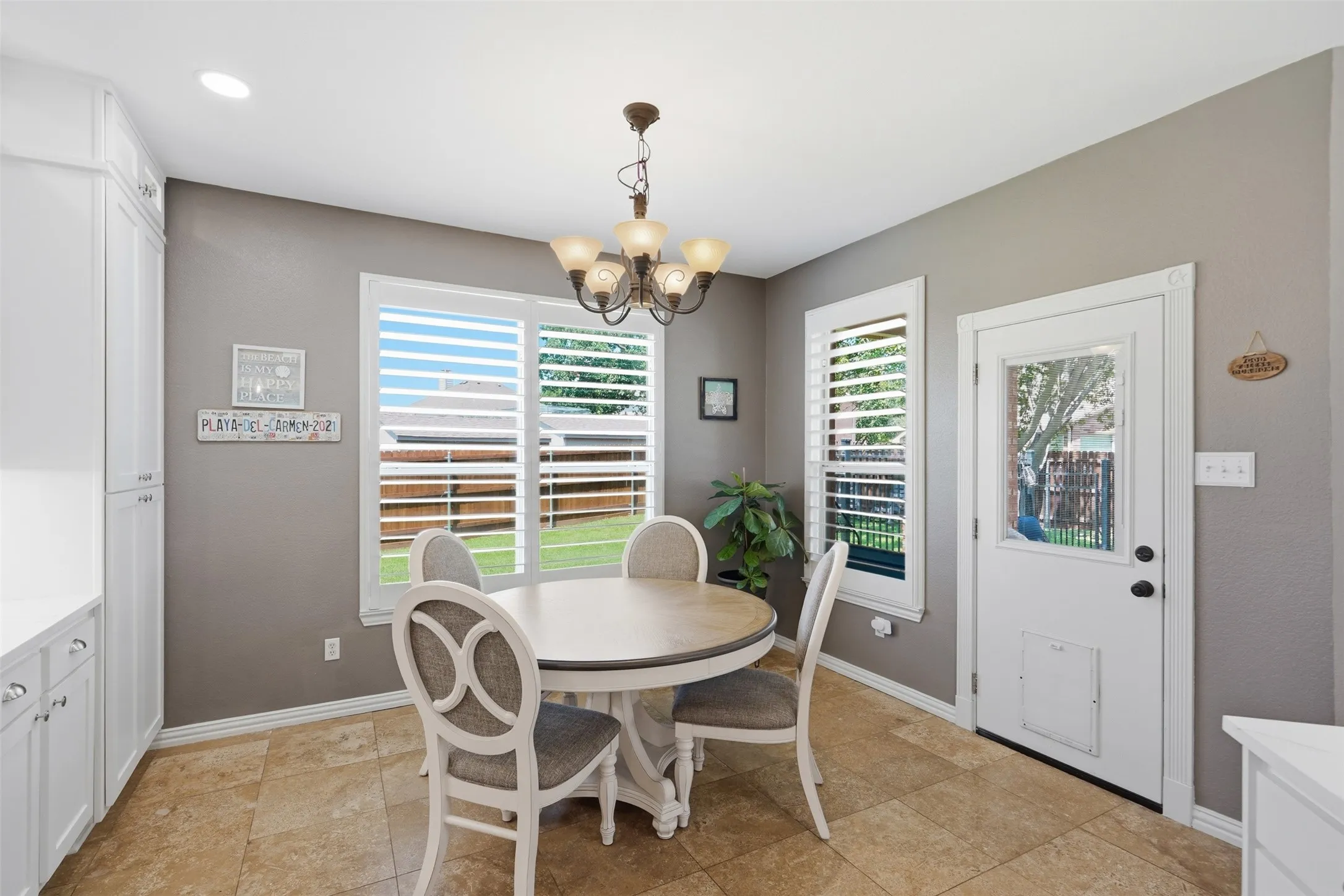 The breakfast room overlooks the huge backyard oasis with saltwater pool spa, covered patio, and lots of yard space.