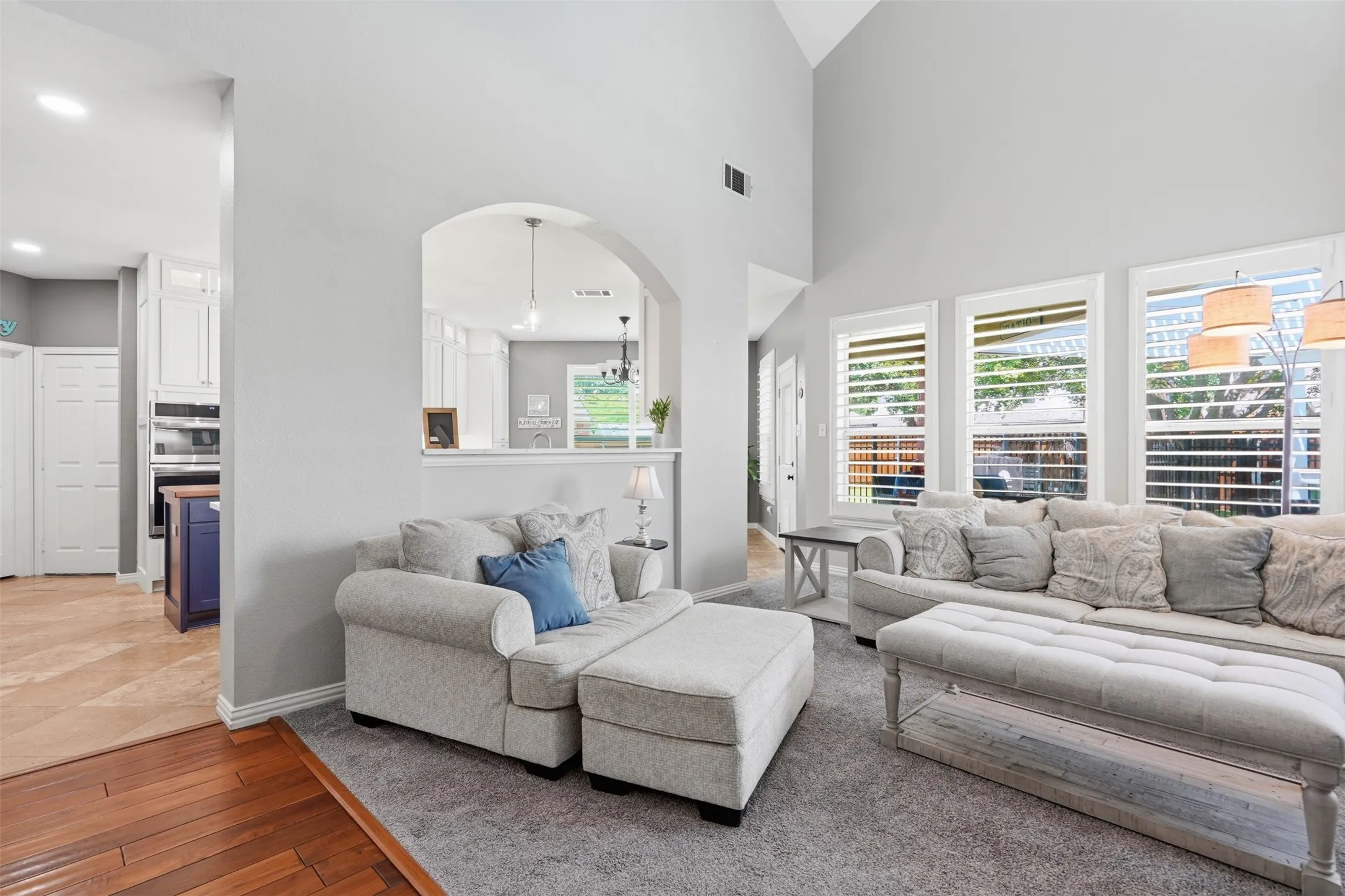 Living area overlooks the backyard patio and pool area.