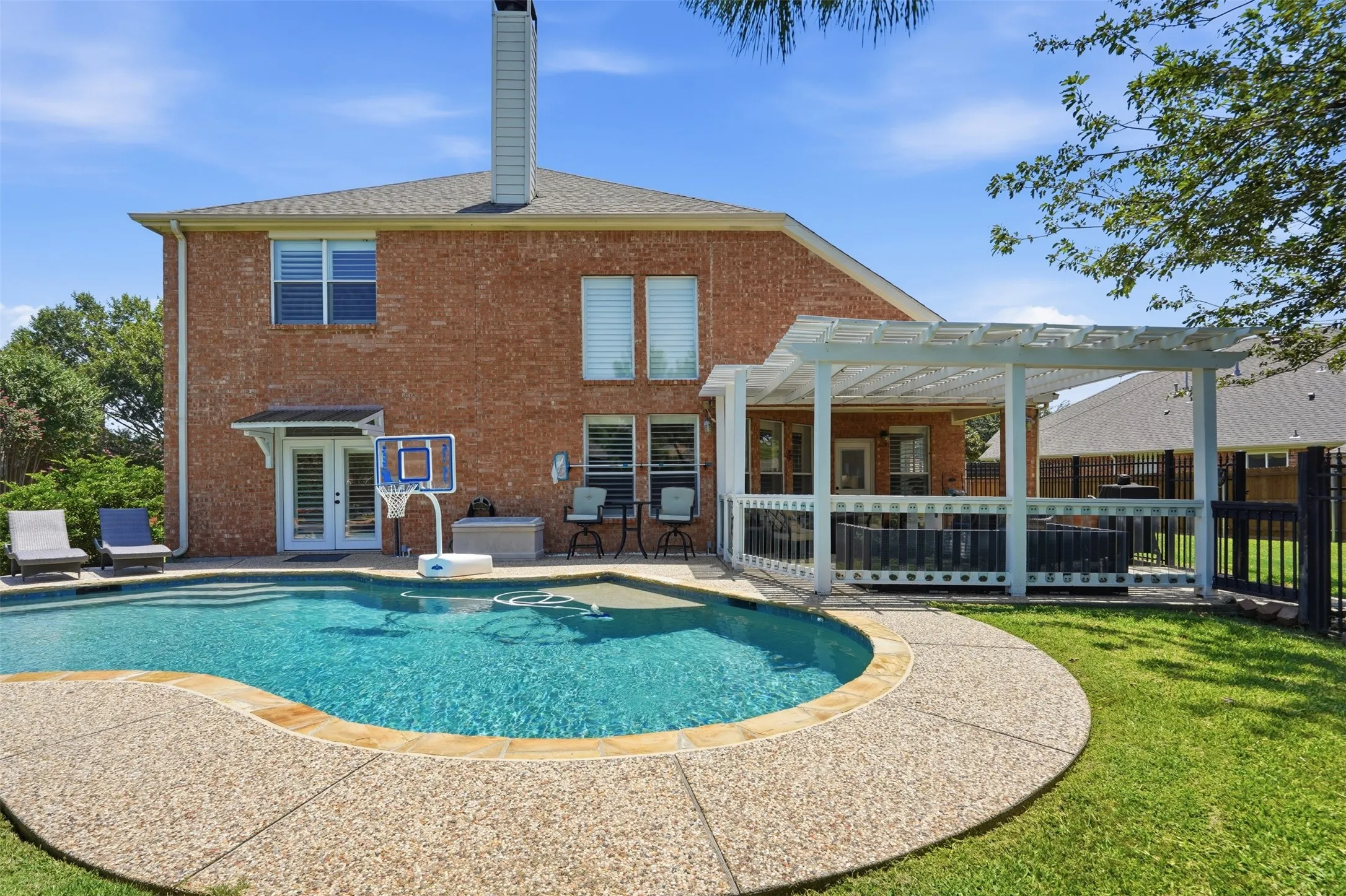 The backyard has a covered patio perfect for entertaining.