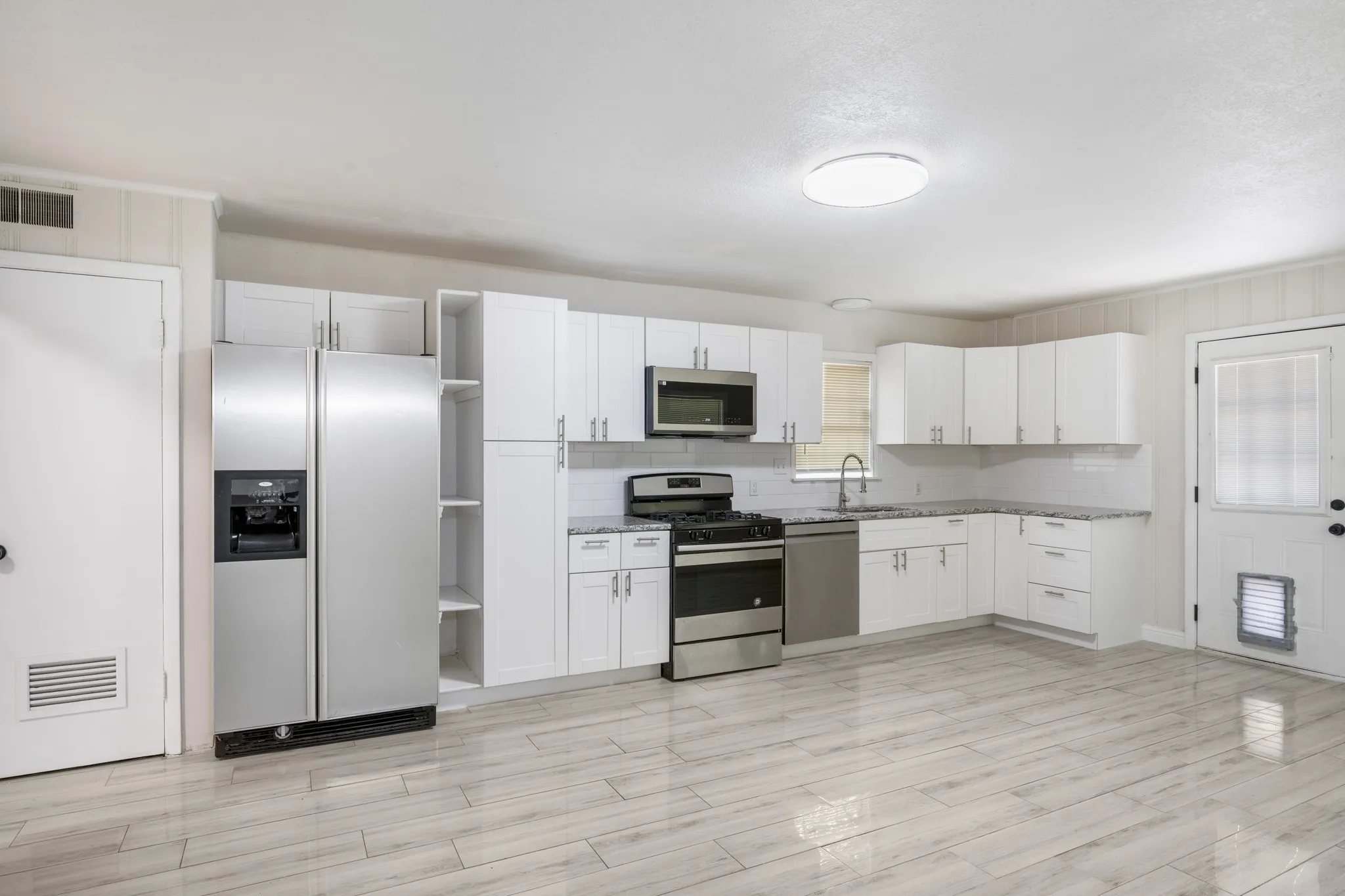 Kitchen features stainless steel appliances.