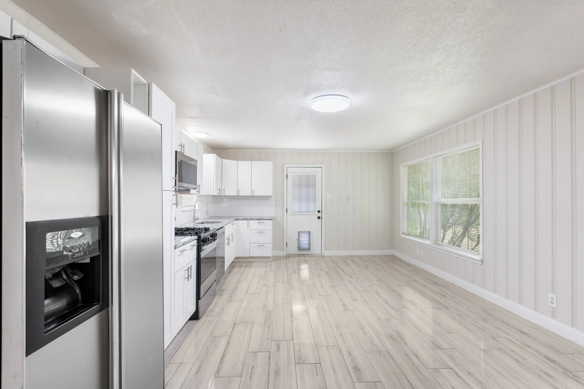 Spacious kitchen has room for an island to be added. It also features hook ups for washer and dryer which are also available in the garage.