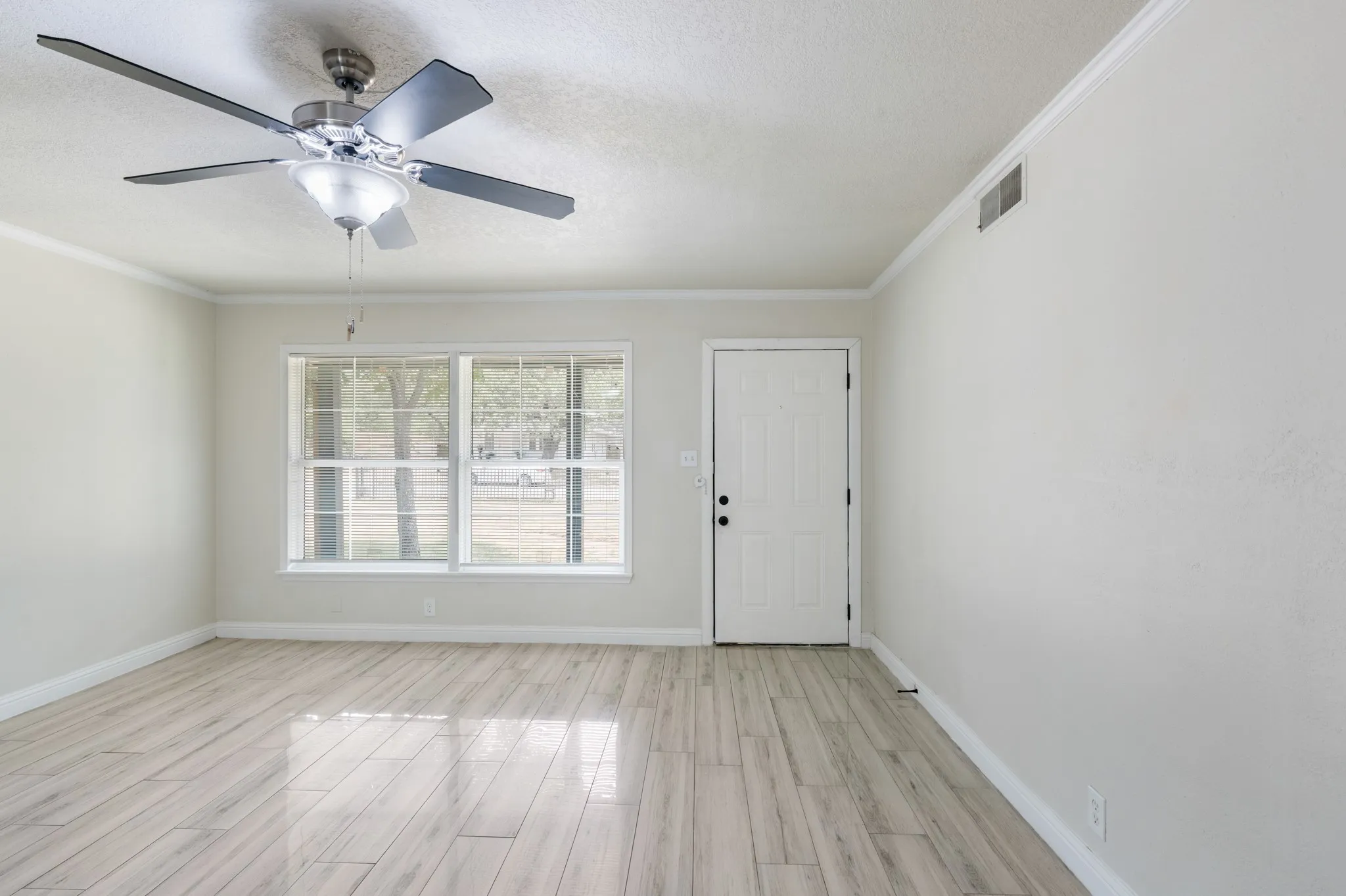 Living room features wood look tile.