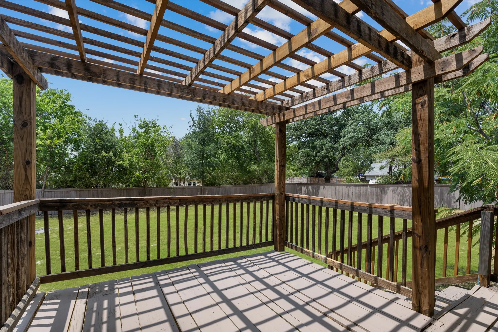 Backyard features a covered deck.