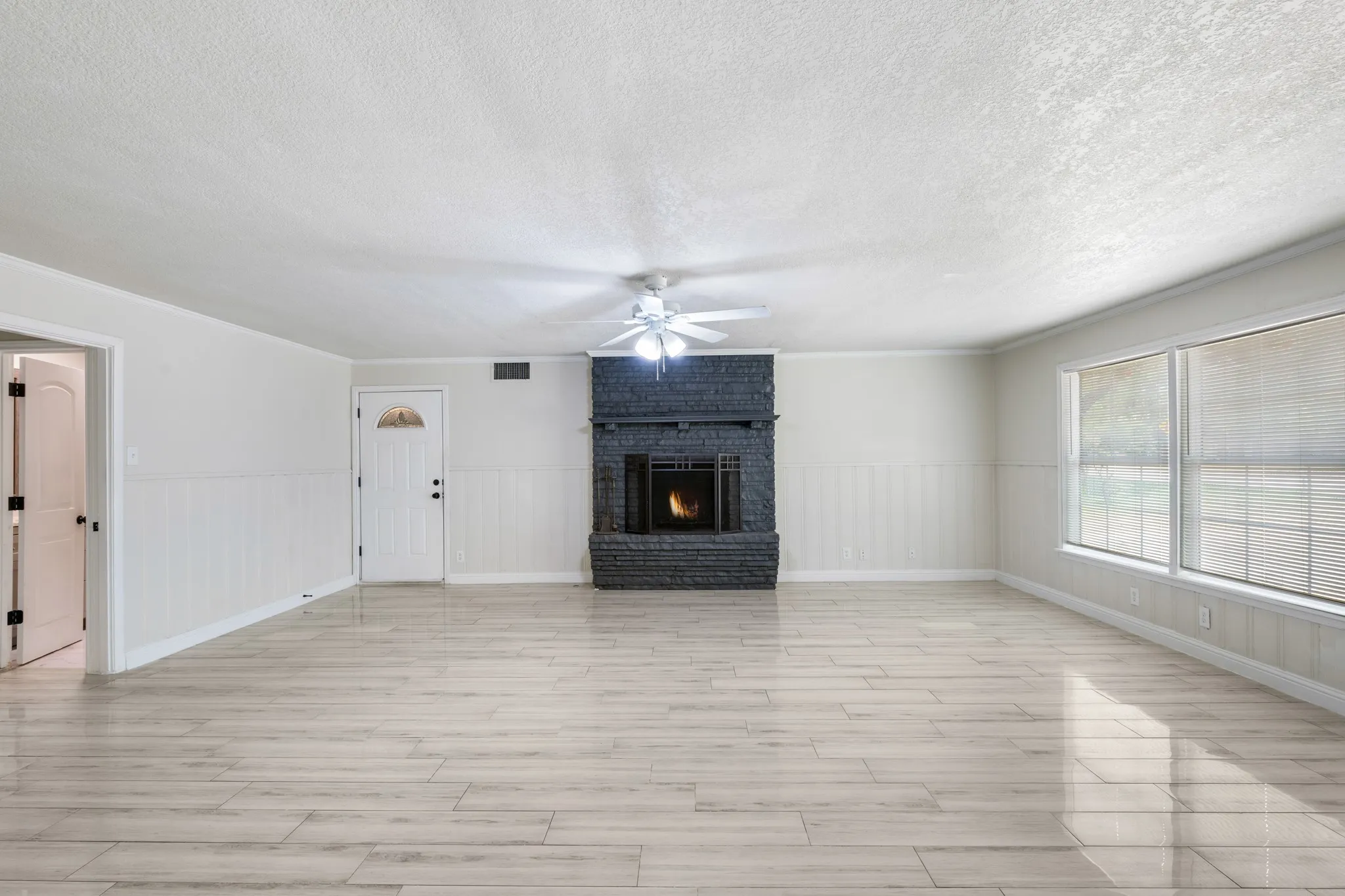 Large secondary living room features a floor to ceiling fireplace.