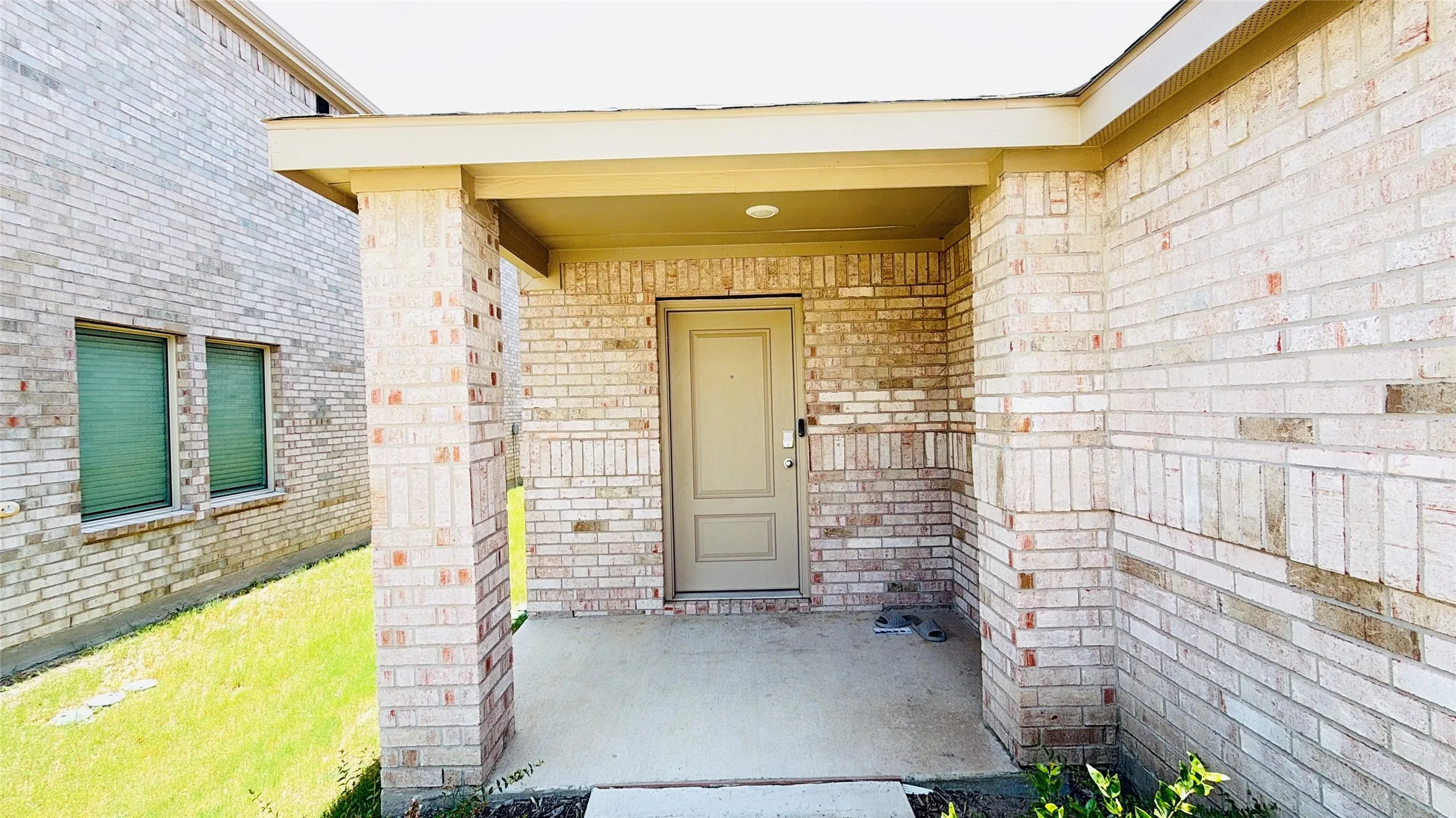 Brick exterior with a covered entry