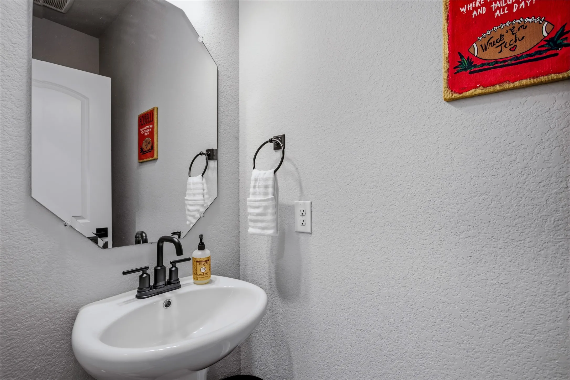 Well-appointed powder room conveniently located for guests and everyday living.
