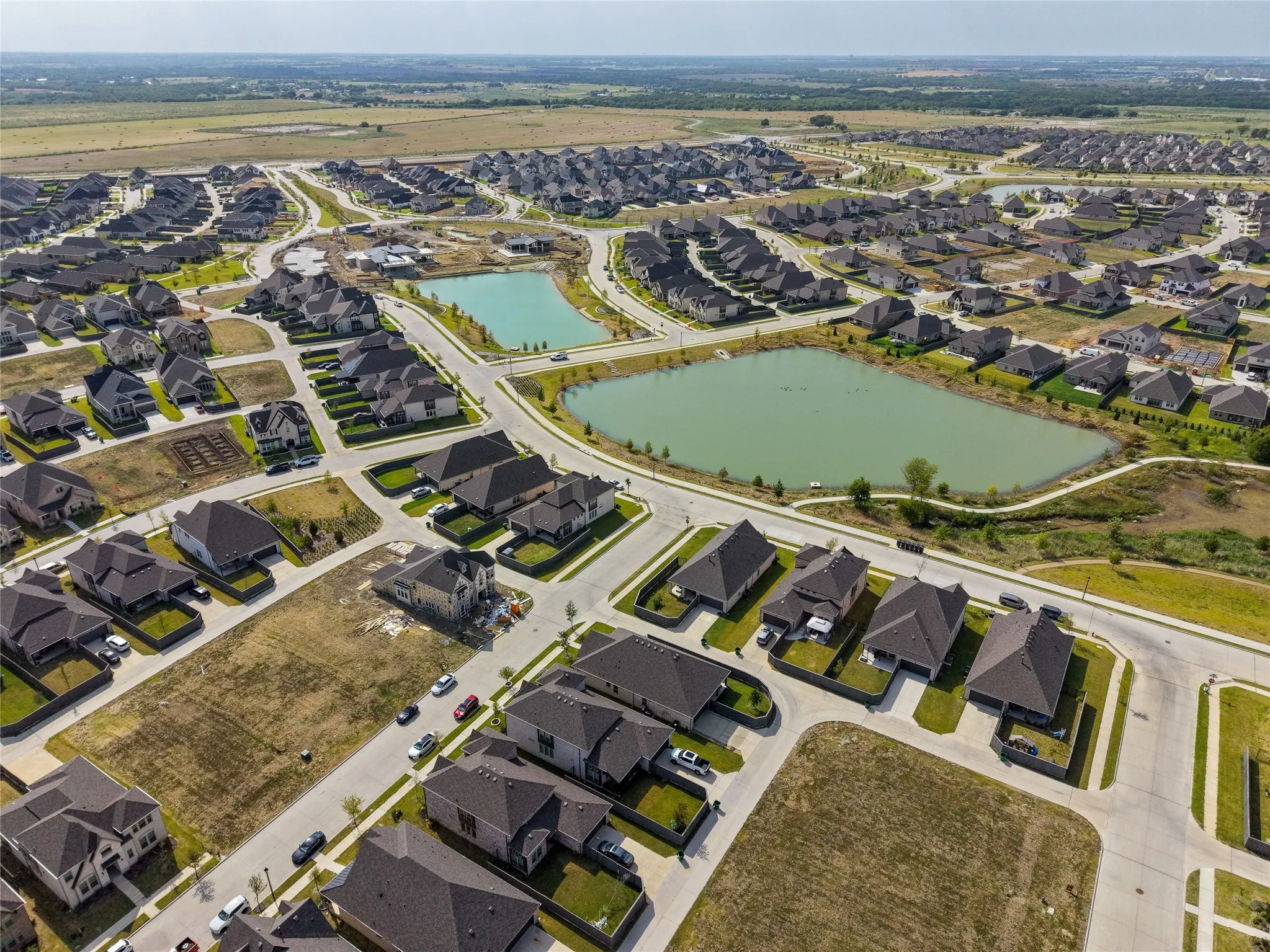 Elevated perspective highlighting the community's thoughtful layout, green spaces, and surrounding amenities.