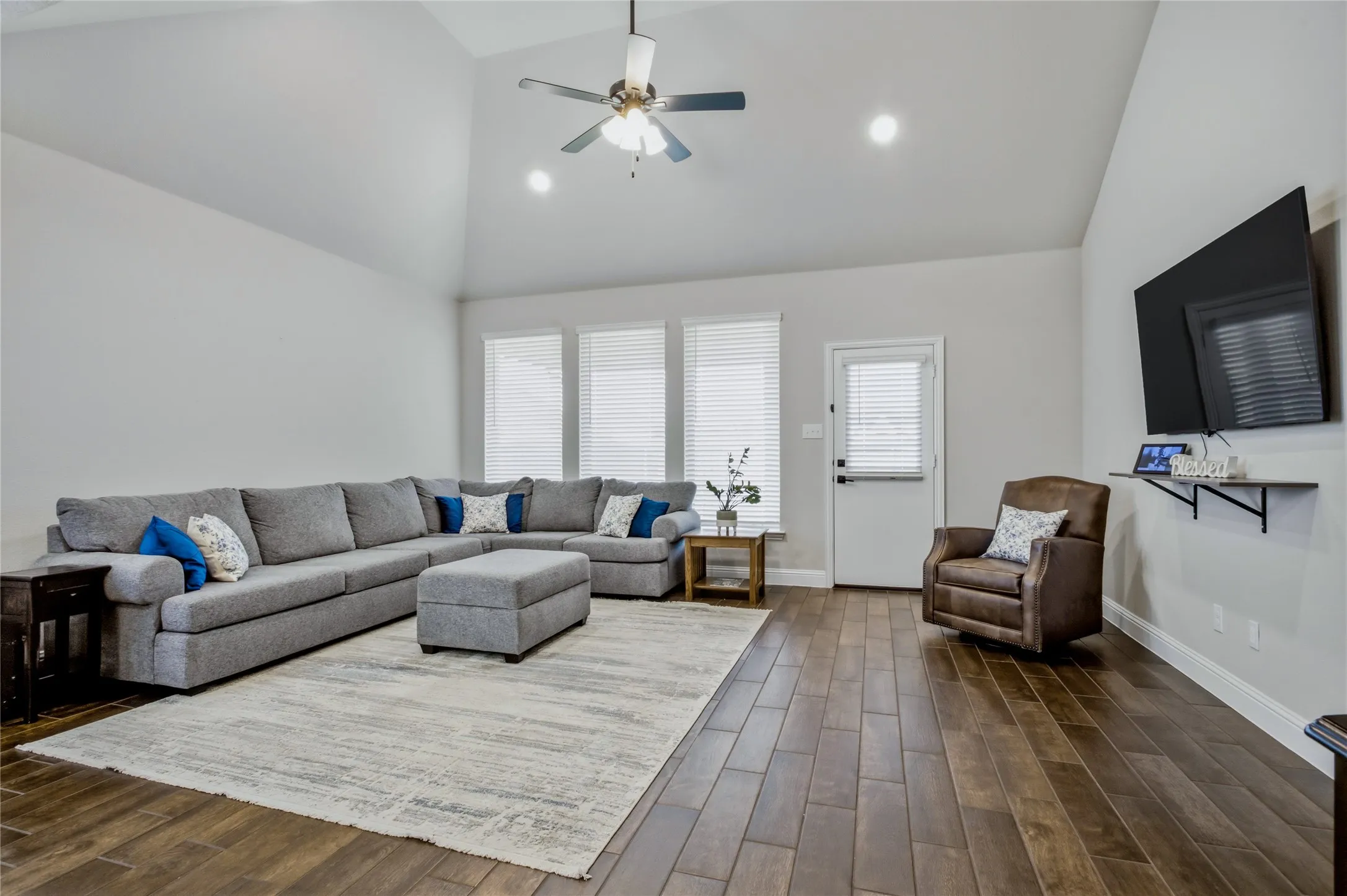 Spacious living area featuring high ceilings, abundant natural light, and an inviting open layout.