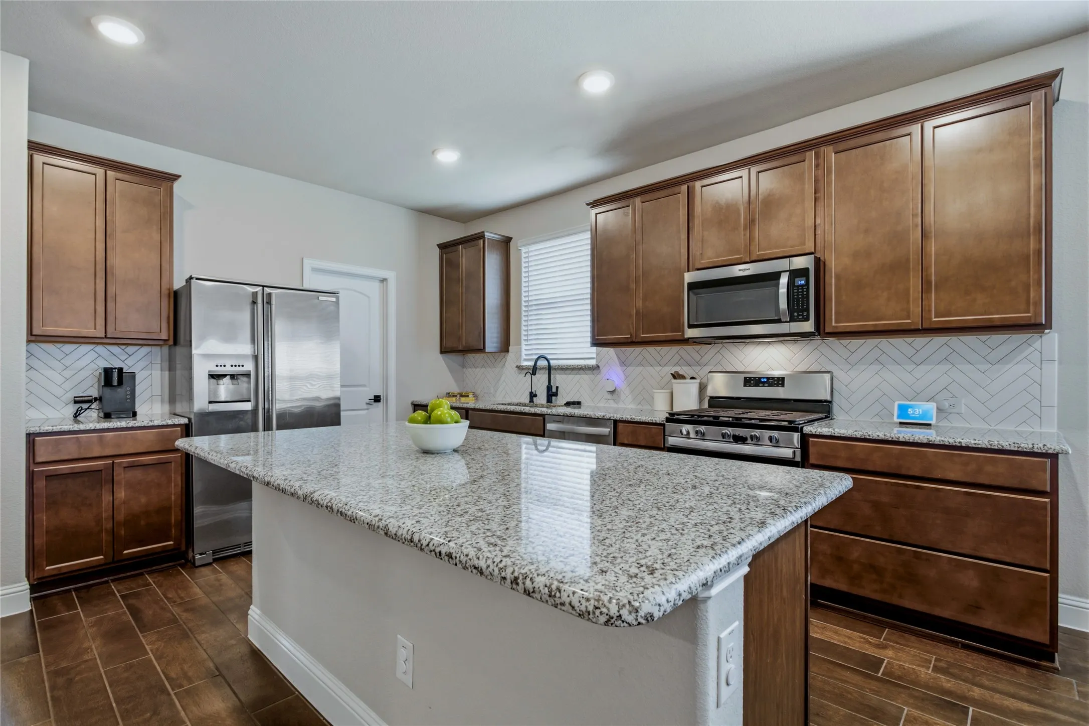 Warm cabinetry, ample counter space, and a functional layout create an inviting kitchen.