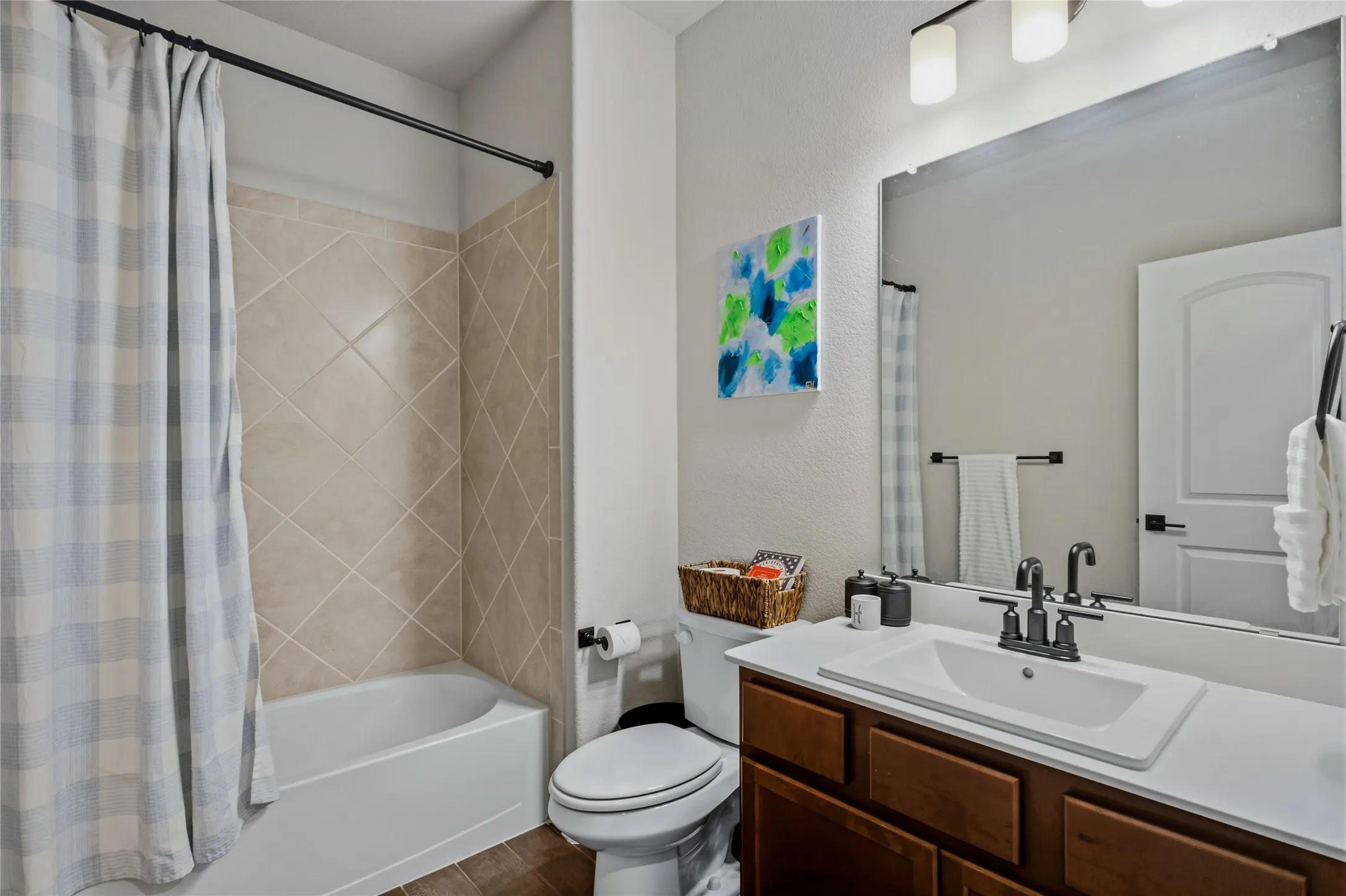 Bright and functional full bathroom with generous vanity space and a clean, modern design.