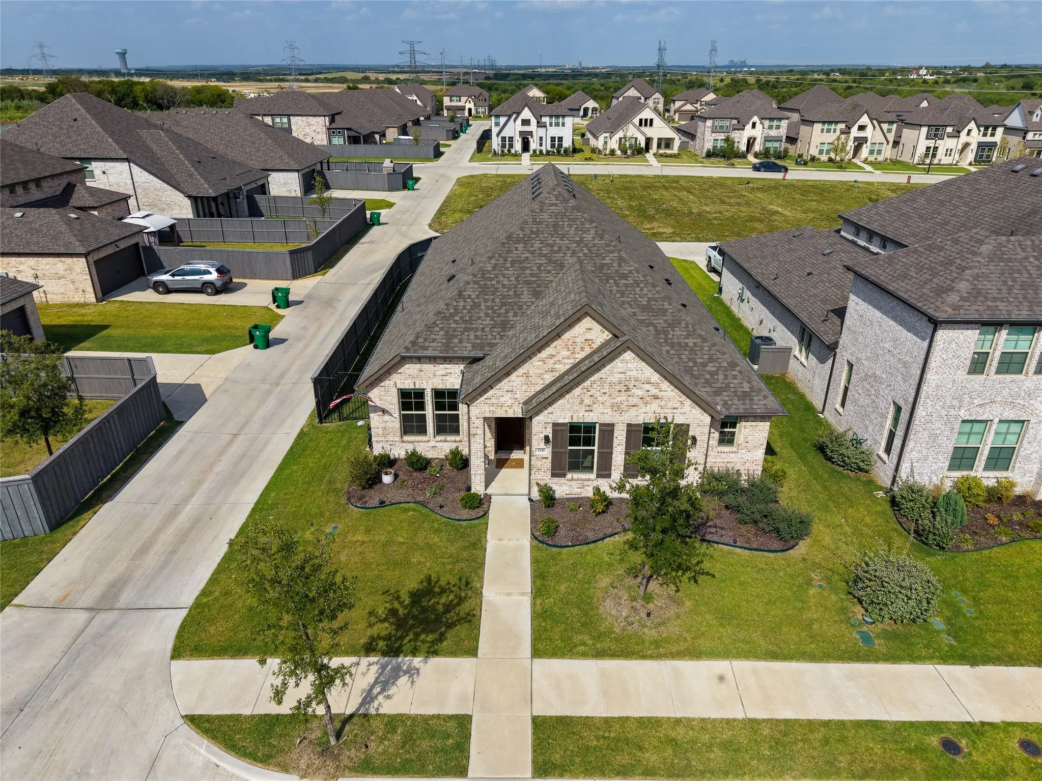 Aerial perspective showcasing the home, surrounding neighborhood, and nearby community amenities.