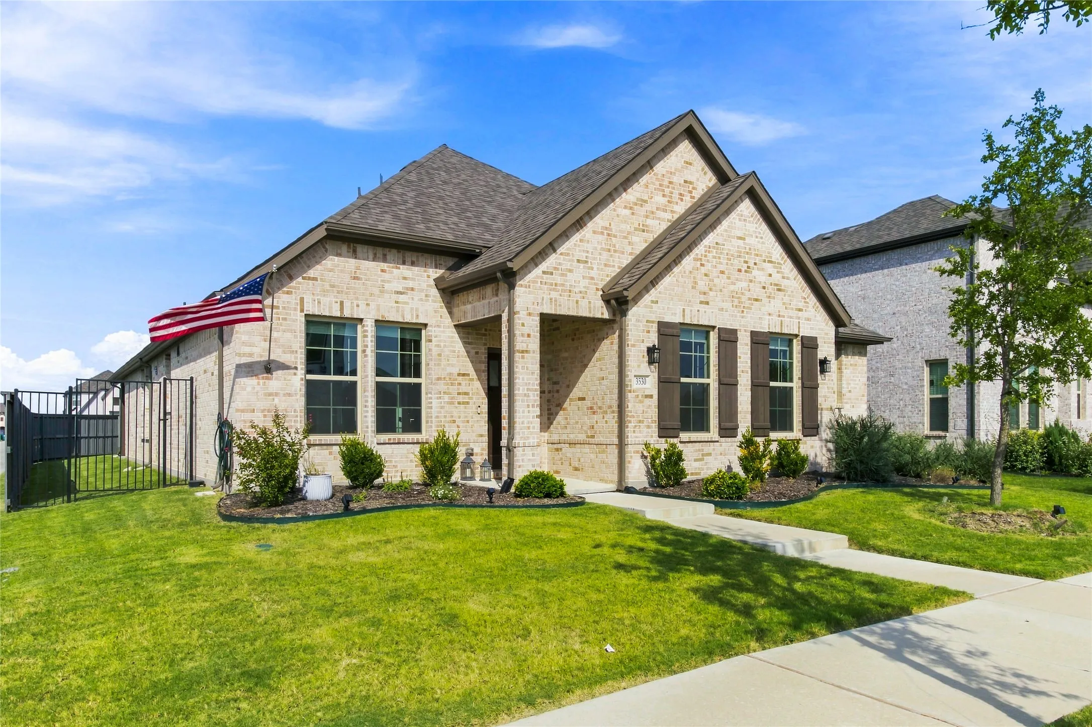 Mature landscaping and a neatly maintained lawn enhance the home's curb appeal.