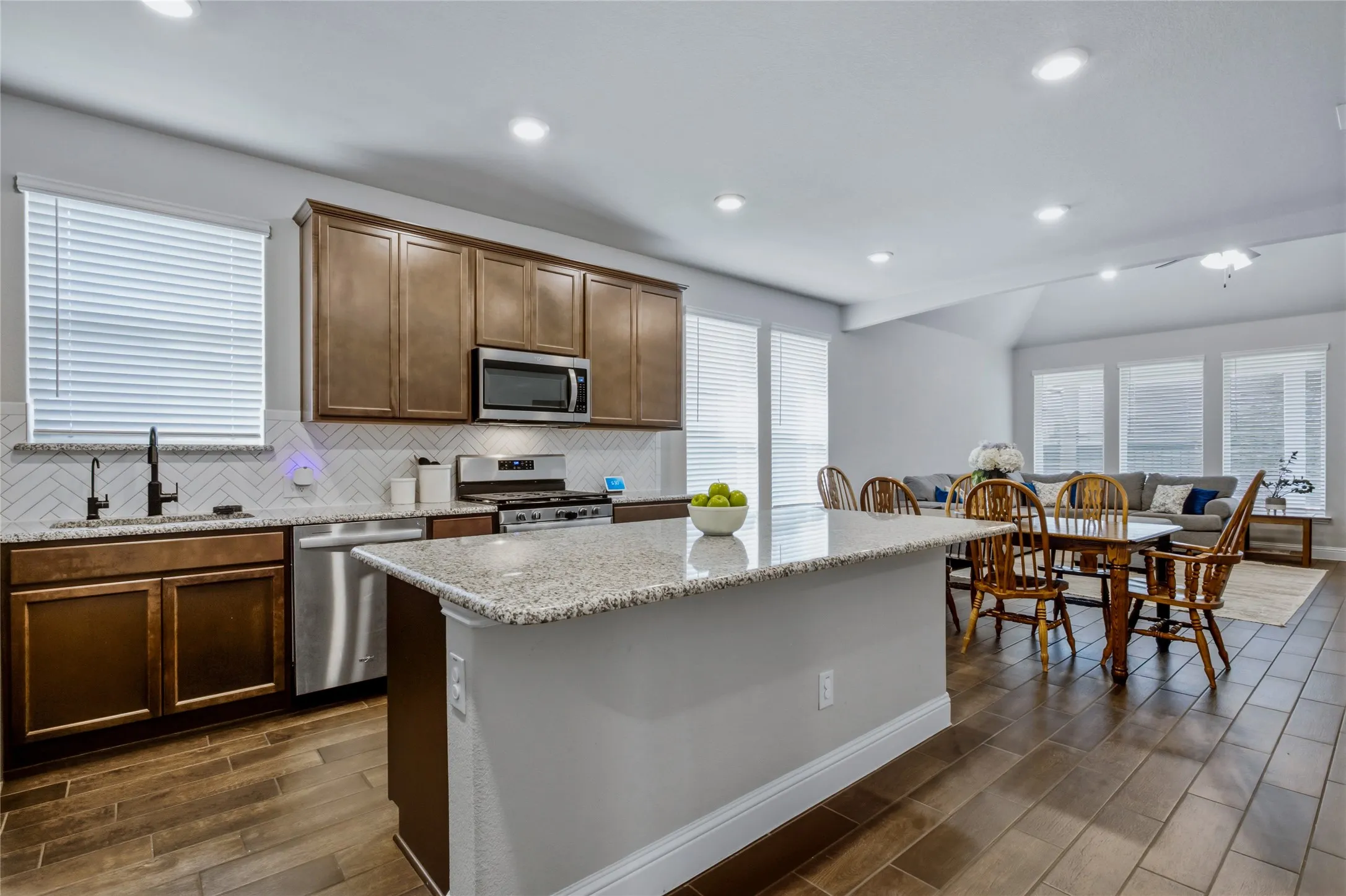 Generous center island anchors the kitchen while providing additional prep and gathering space.