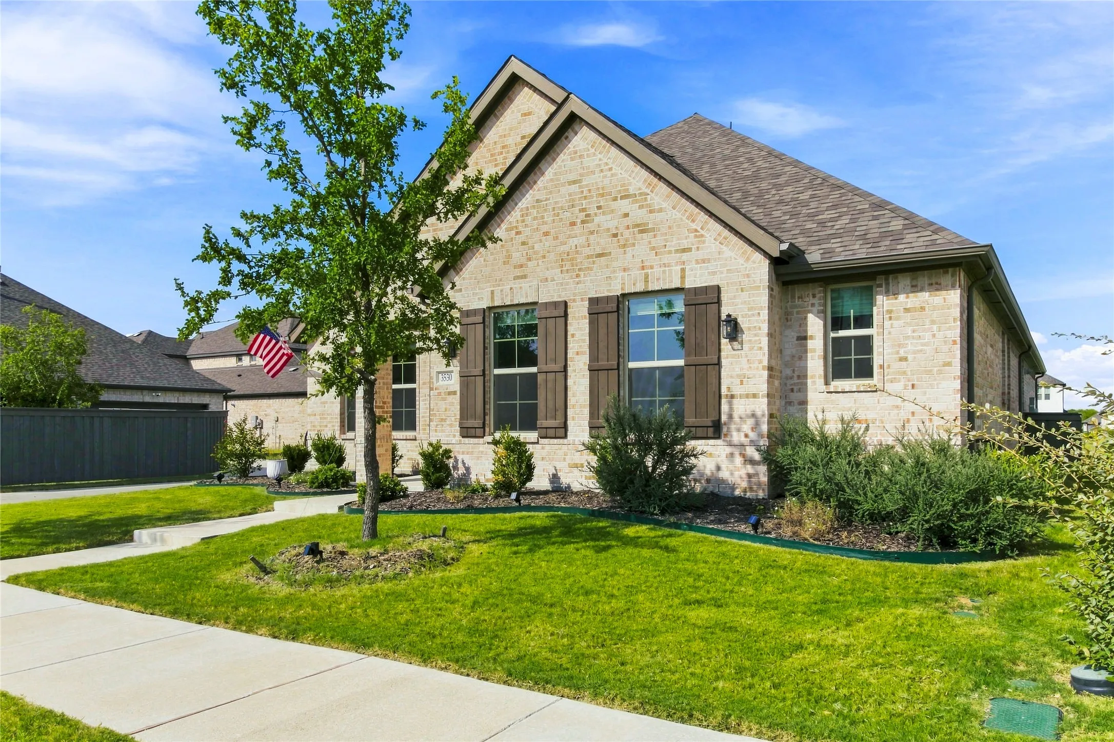Charming elevation with a spacious front lawn and thoughtfully landscaped surroundings.