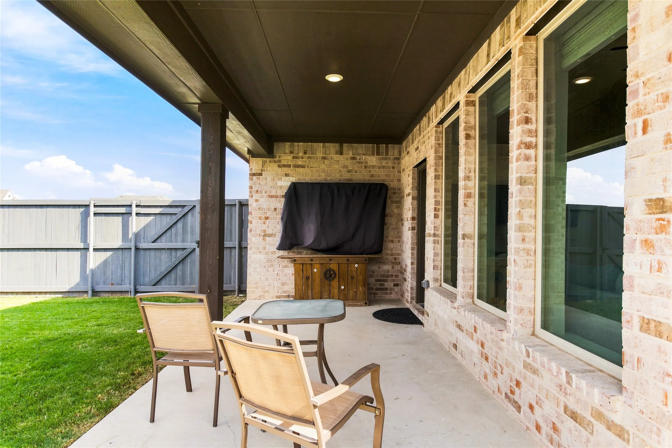 Spacious covered patio creates an inviting outdoor setting for relaxing, dining, or entertaining.