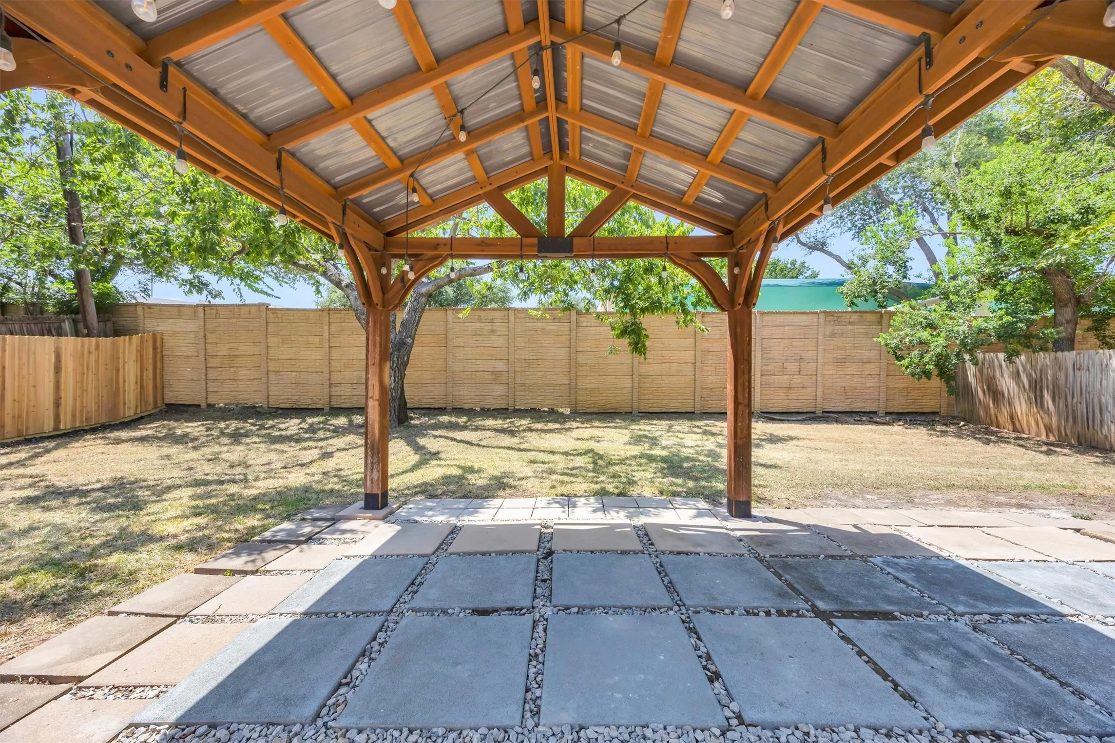 Costco pergola anchored to the concrete patio.