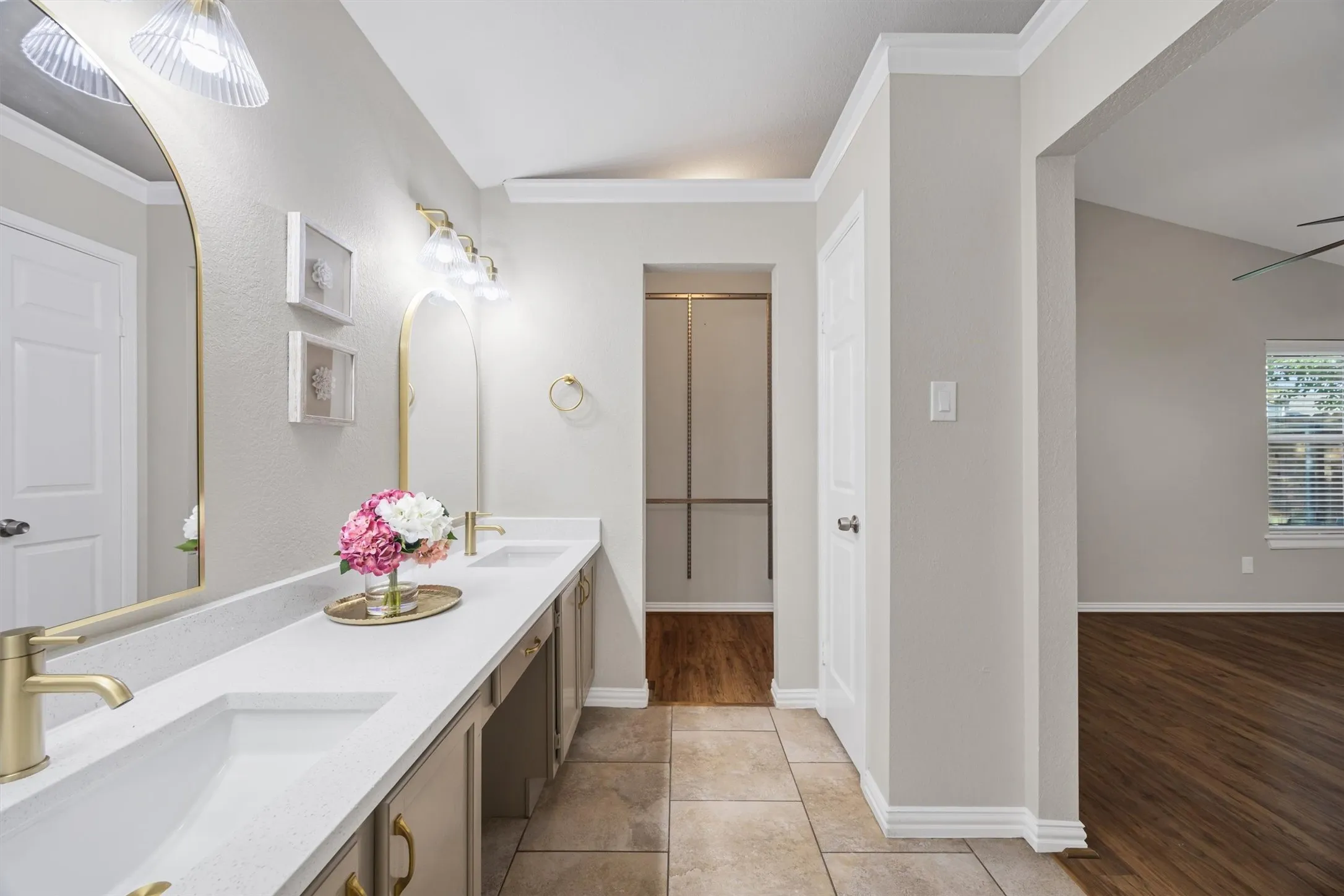 Updated primary bathroom with new quartz counters, champagne faucets, updated vanity with paint & fixtures.