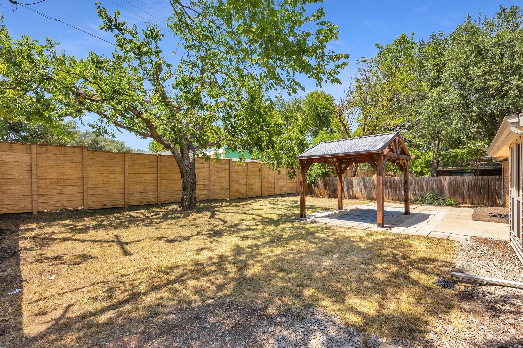 Brick privacy fence, backs up to medical offices.
