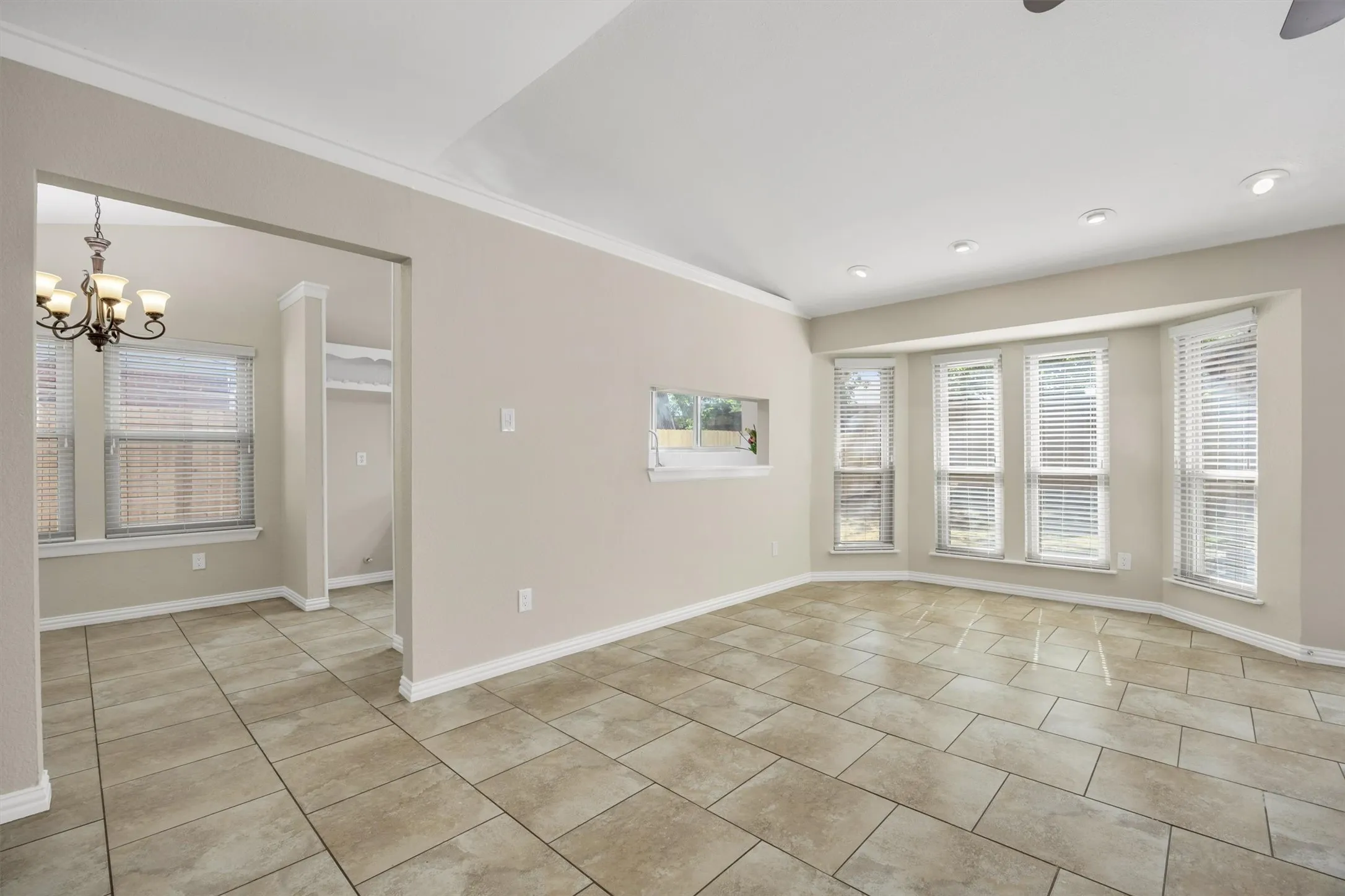 Doorway to the left is nook leading to kitchen. Kitchen service window in the center. Bay window fits dining room table.