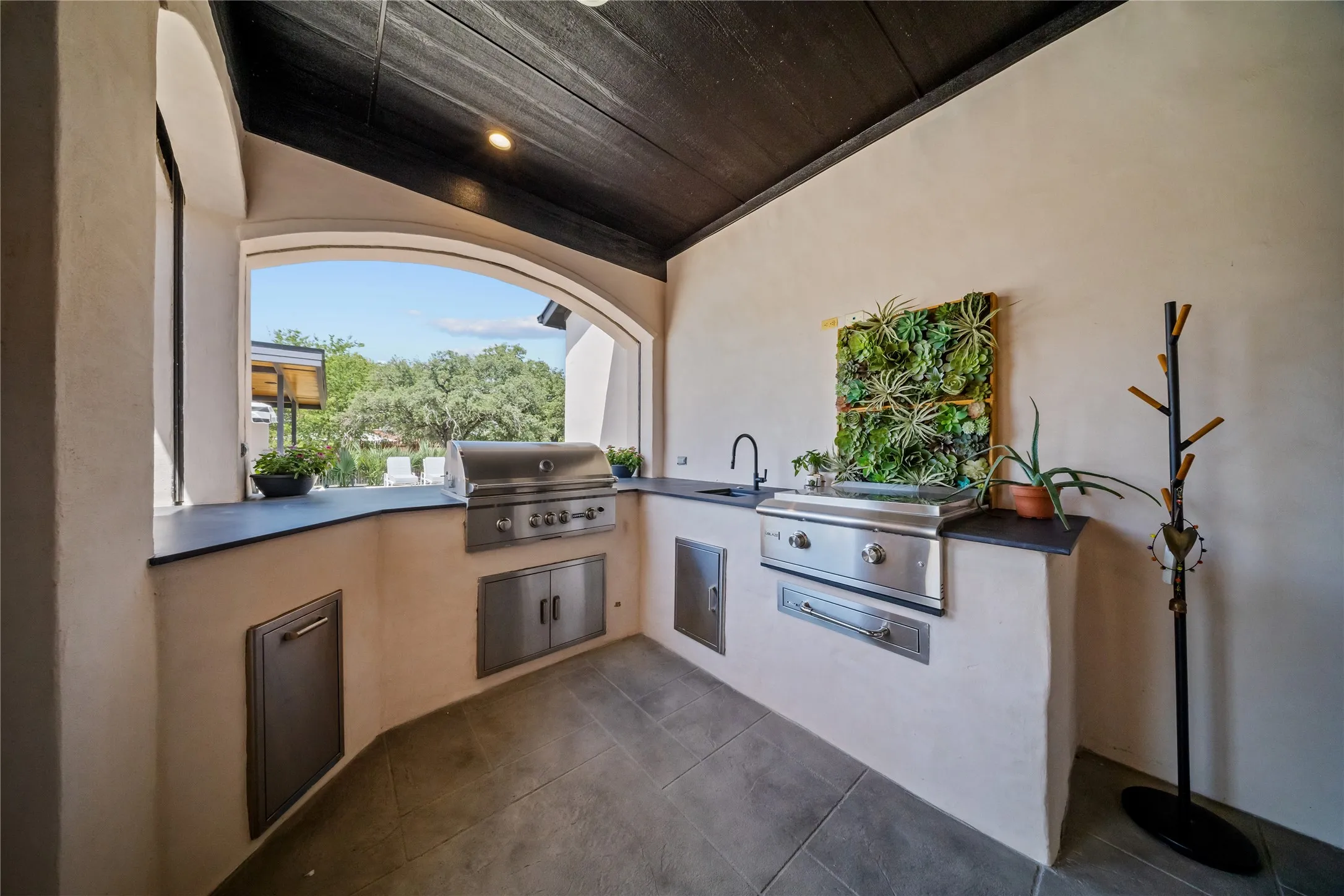 Grill and hibachi added; new countertops installed in outdoor kitchen area.
