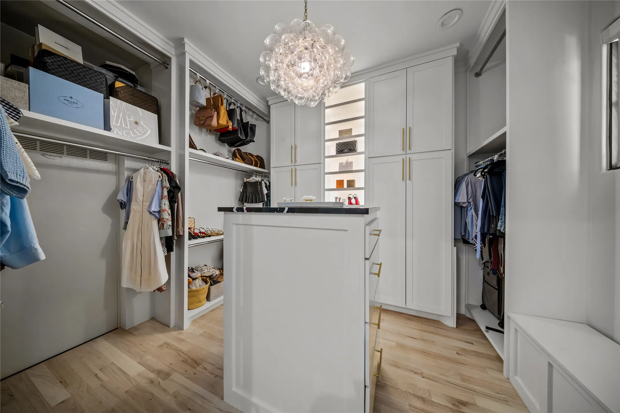 Master closet with built-ins to store handbags, jewelry, and has a metal storm room.