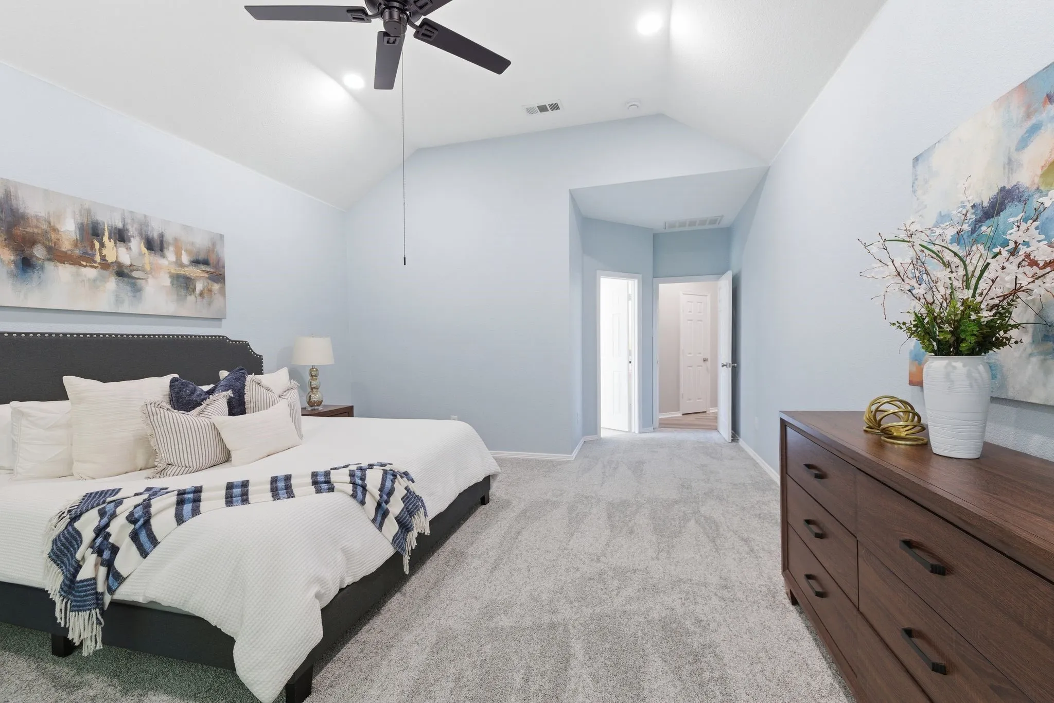 Vaulted ceilings featuring recessed lighting and a ceiling fan