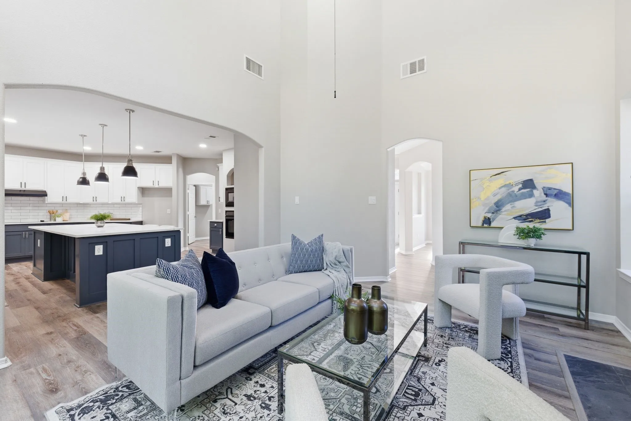 Expansive living area with high ceilings and wood-finish flooring