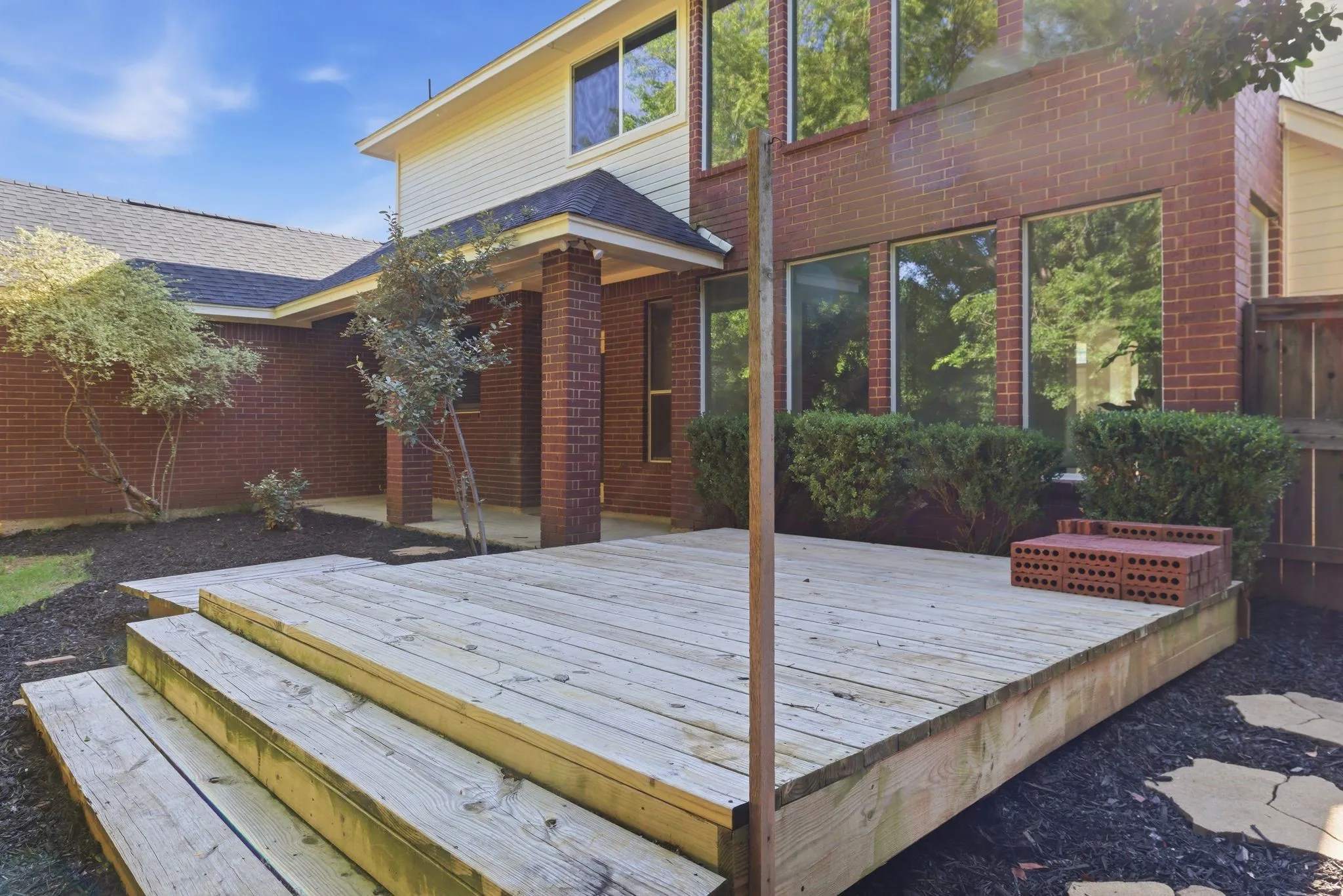 Multi-level wood deck featuring wide steps and a spacious platform