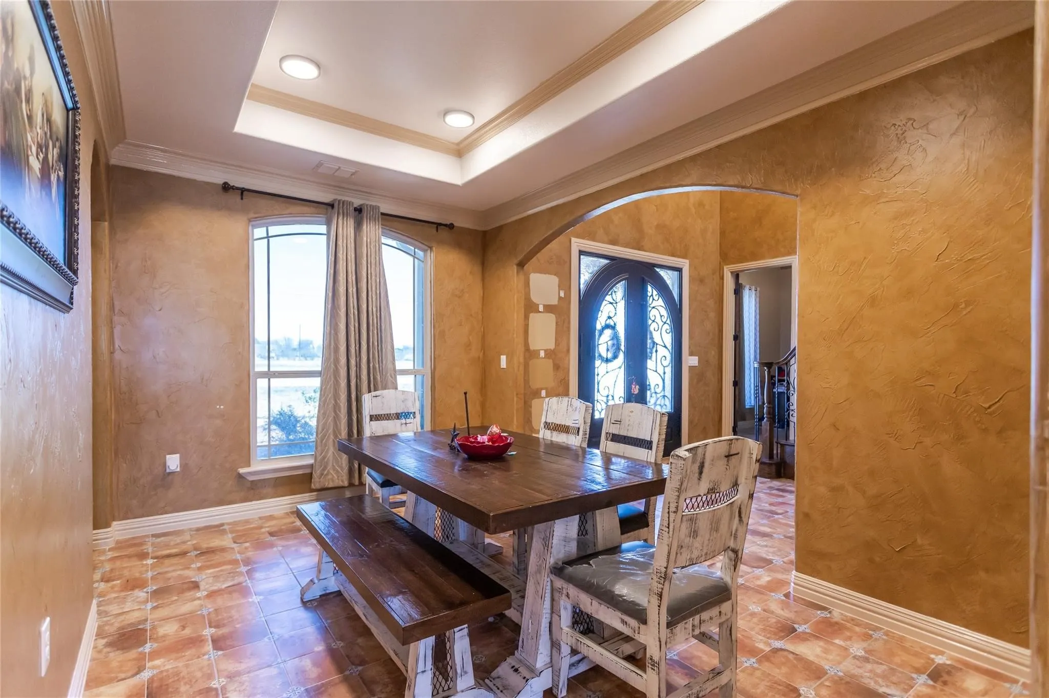 Arched double entry doors, recessed ceiling lighting, arched doorway, textured wall finish, and tile flooring