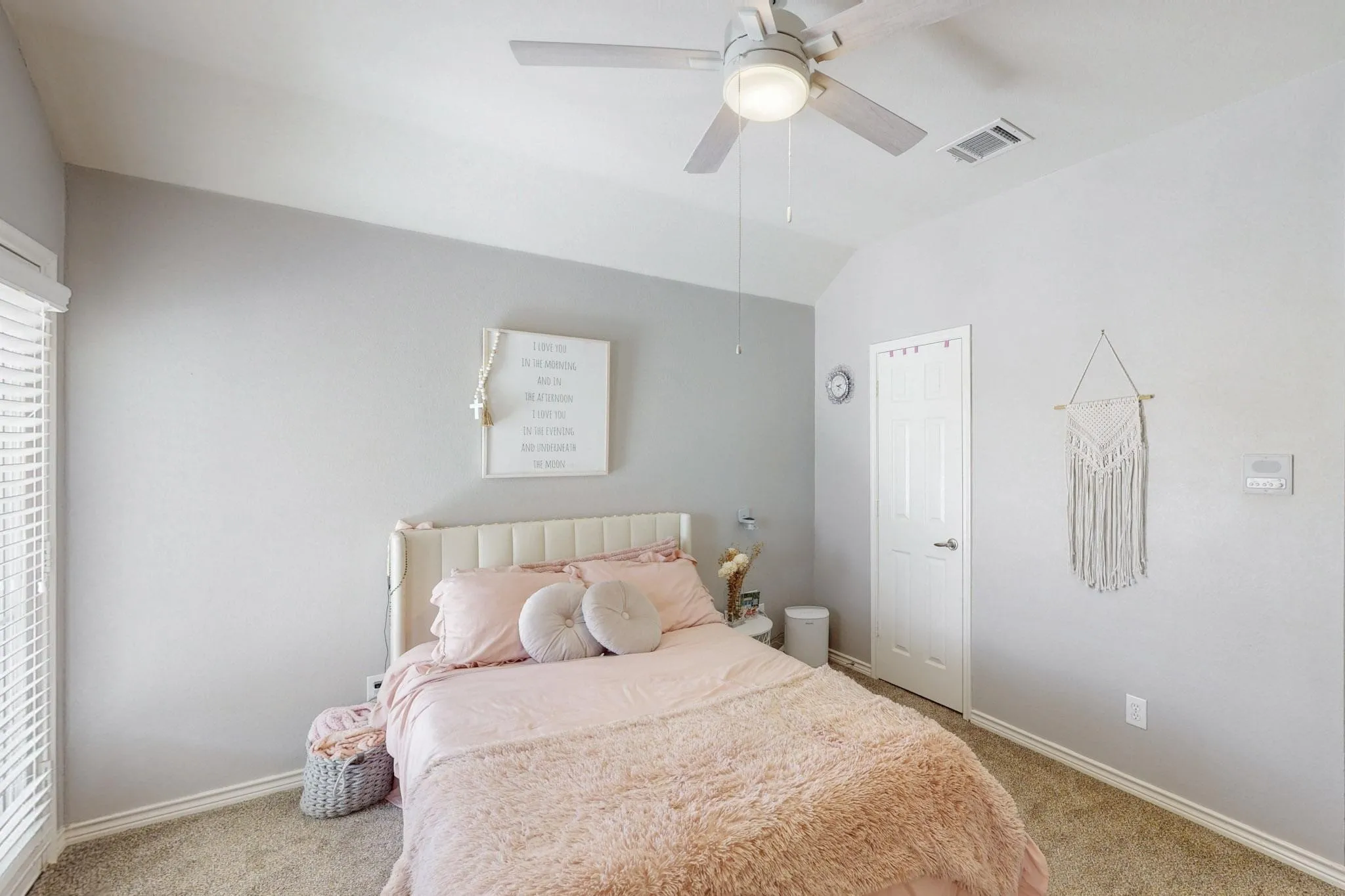 Vaulted ceiling featuring a ceiling fan with integrated lighting, carpet flooring, and window with blinds