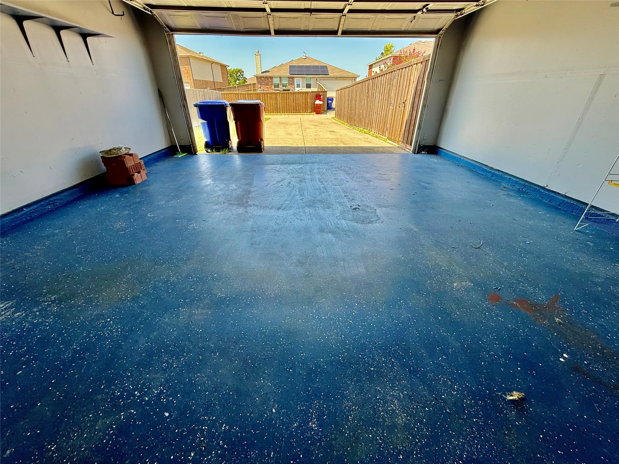 Garage with blue epoxy-coated flooring