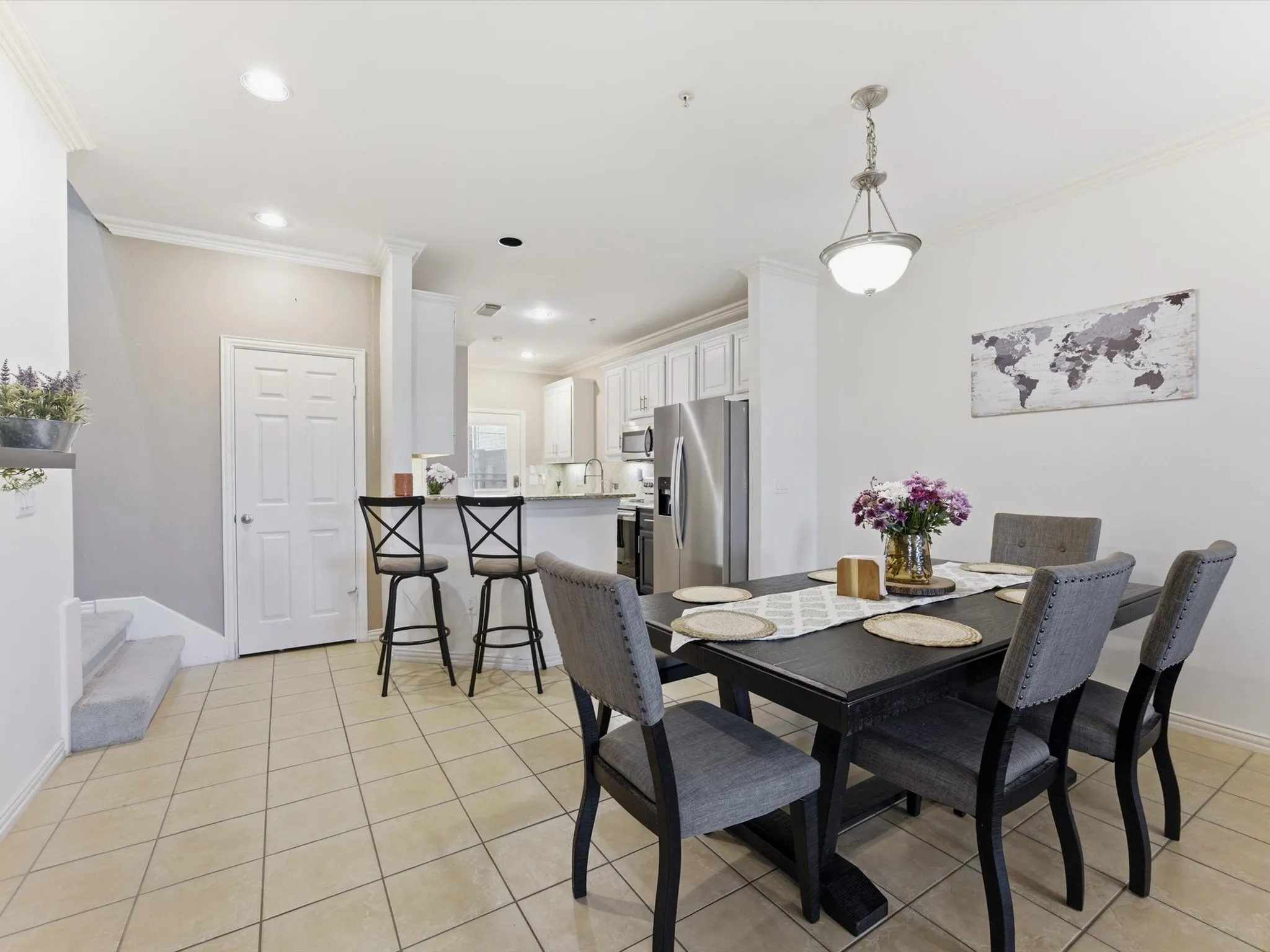 Tile flooring throughout, recessed lighting, and crown molding accents