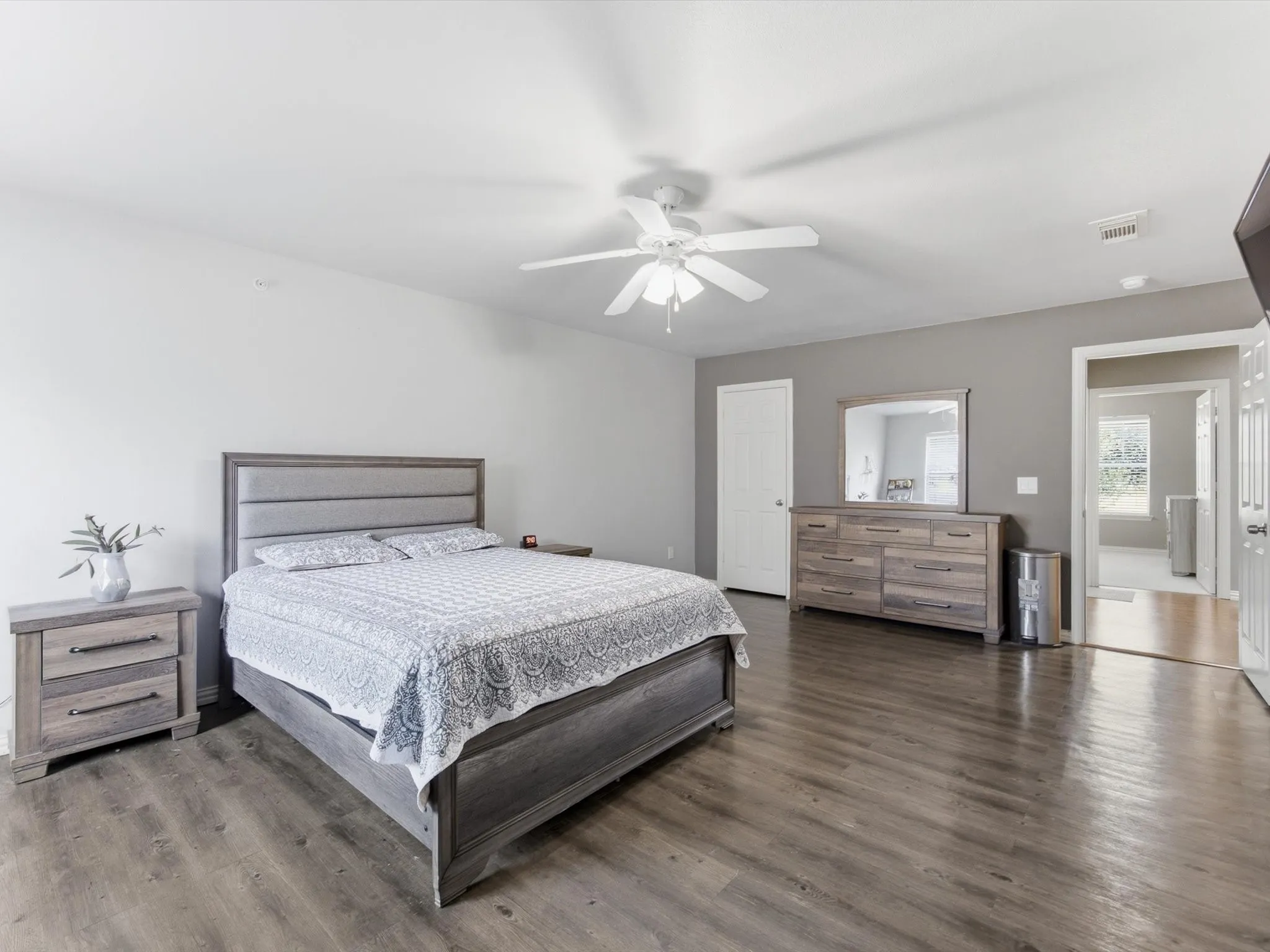 Wood-finish flooring, ceiling fan, and painted walls