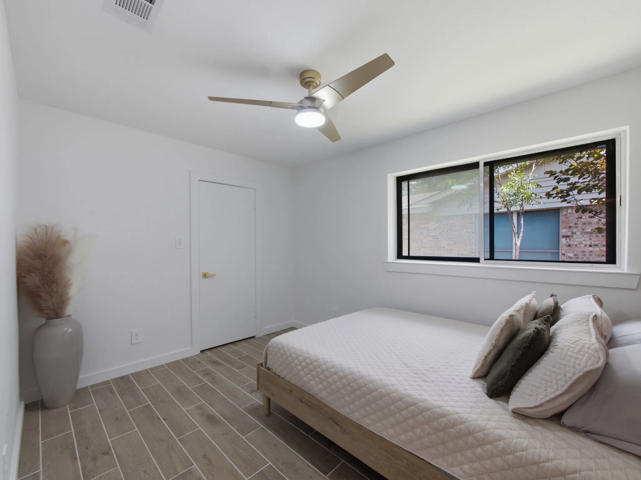 Recessed lighting, ceiling fan with integrated lighting, wood-finish flooring, white trim, and a window with black framing