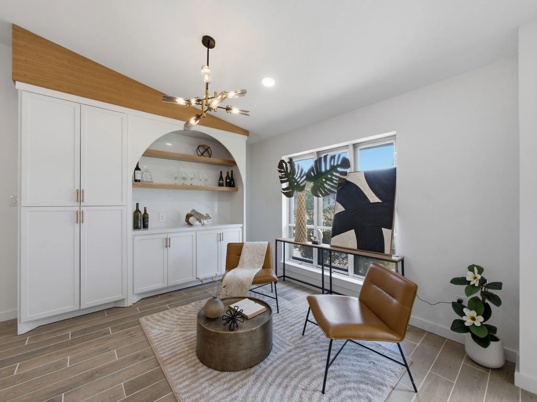 Built-in cabinetry with an arched recess, open wood shelving, and a beverage counter