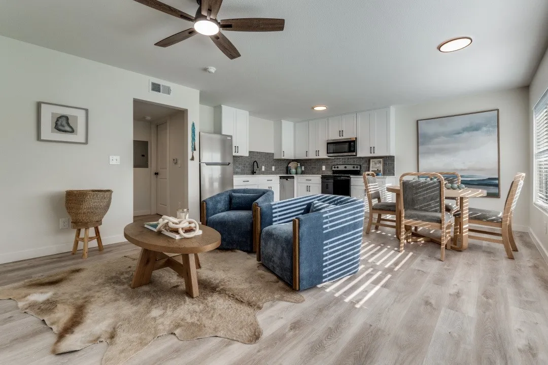 Open-concept living space featuring wood-finish flooring, a ceiling fan, and recessed lighting