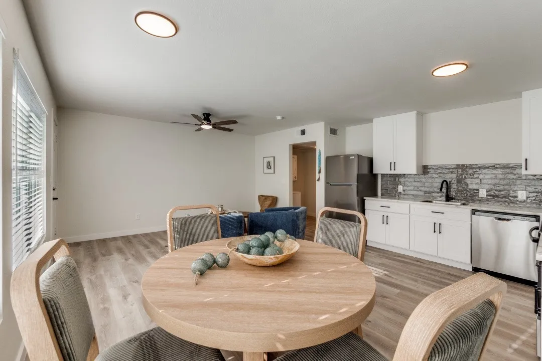 Open-concept living space with wood-finish flooring, recessed ceiling lights, and a ceiling fan