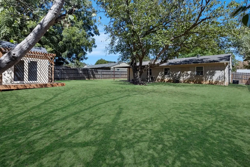 Very large shaded backyard with shed!